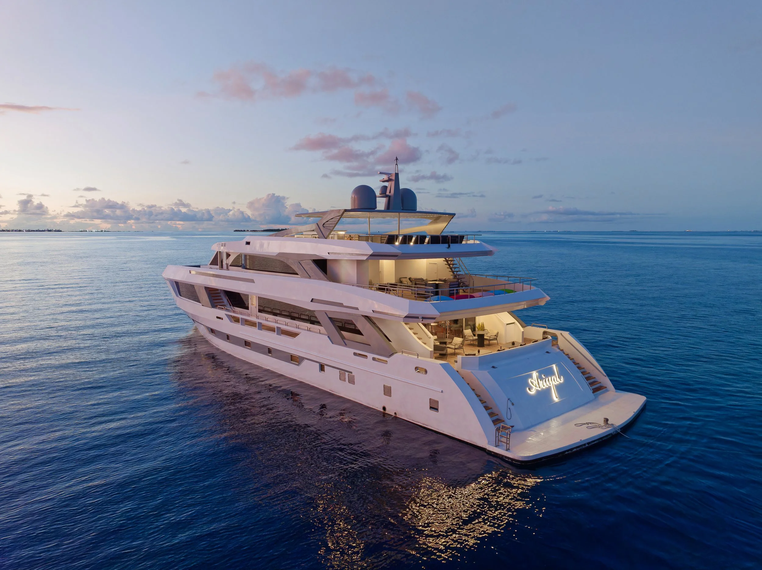 Luxury white yacht named 'Arigat' sailing on calm ocean waters during sunset with a distant shoreline and partly cloudy sky in the background.