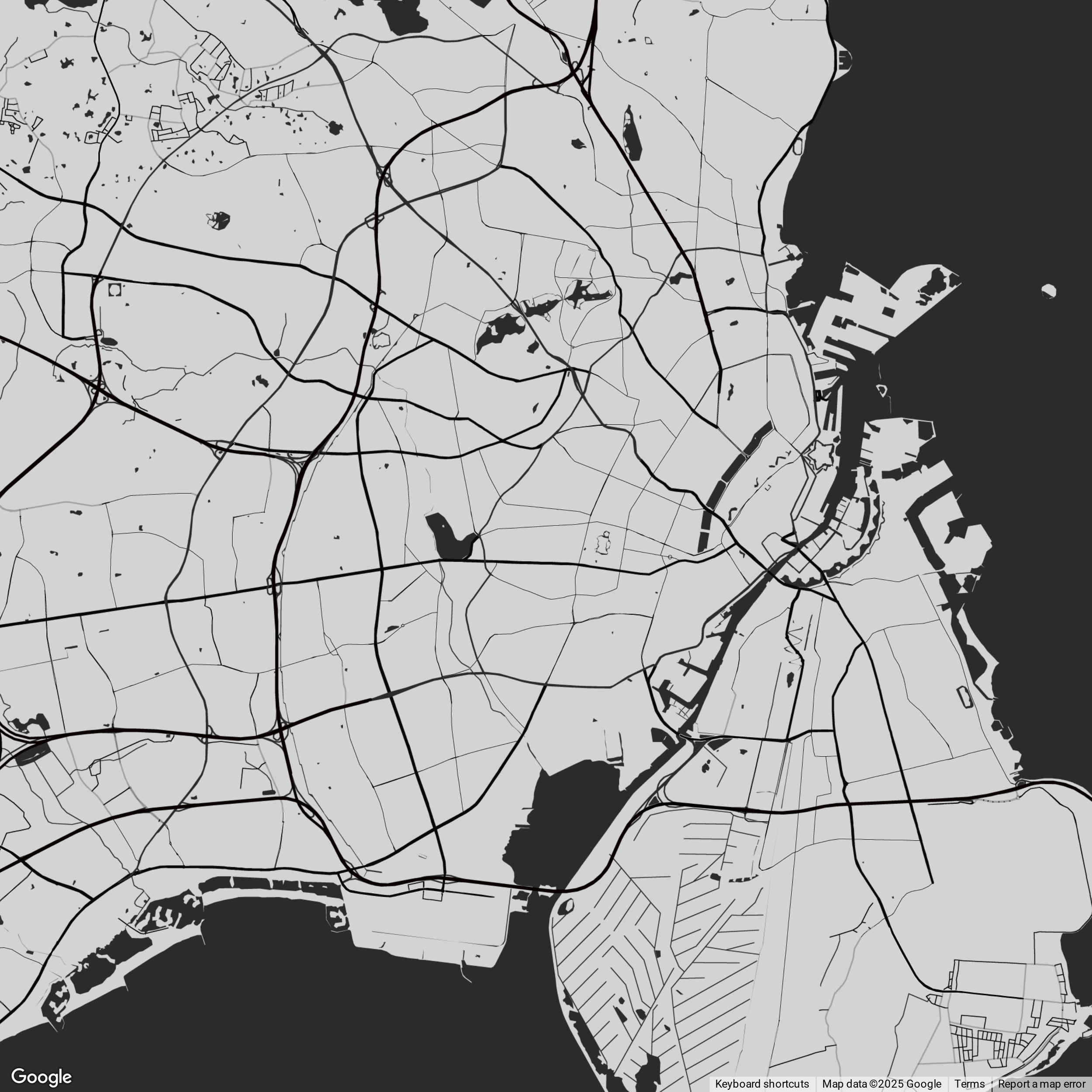 A black and white map showing roads, water bodies, and land areas of a city and surrounding region