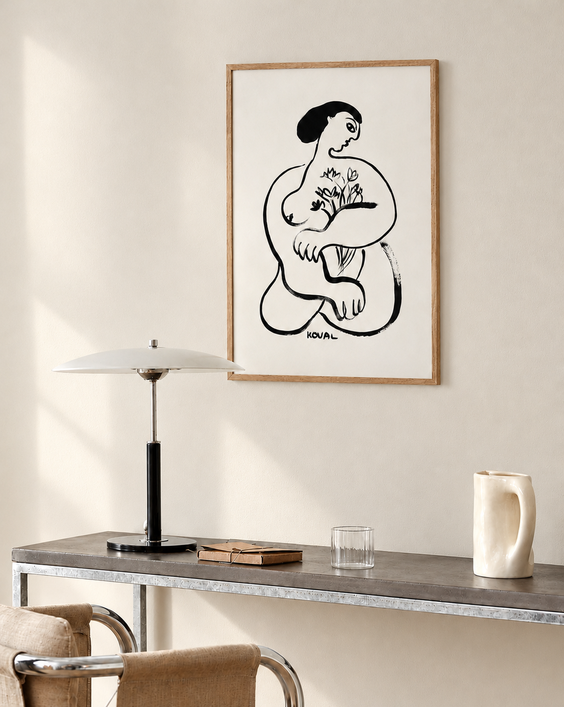 Framed print “Girl with Flowers. July.” on a dark console table beside a table lamp and a wooden chair