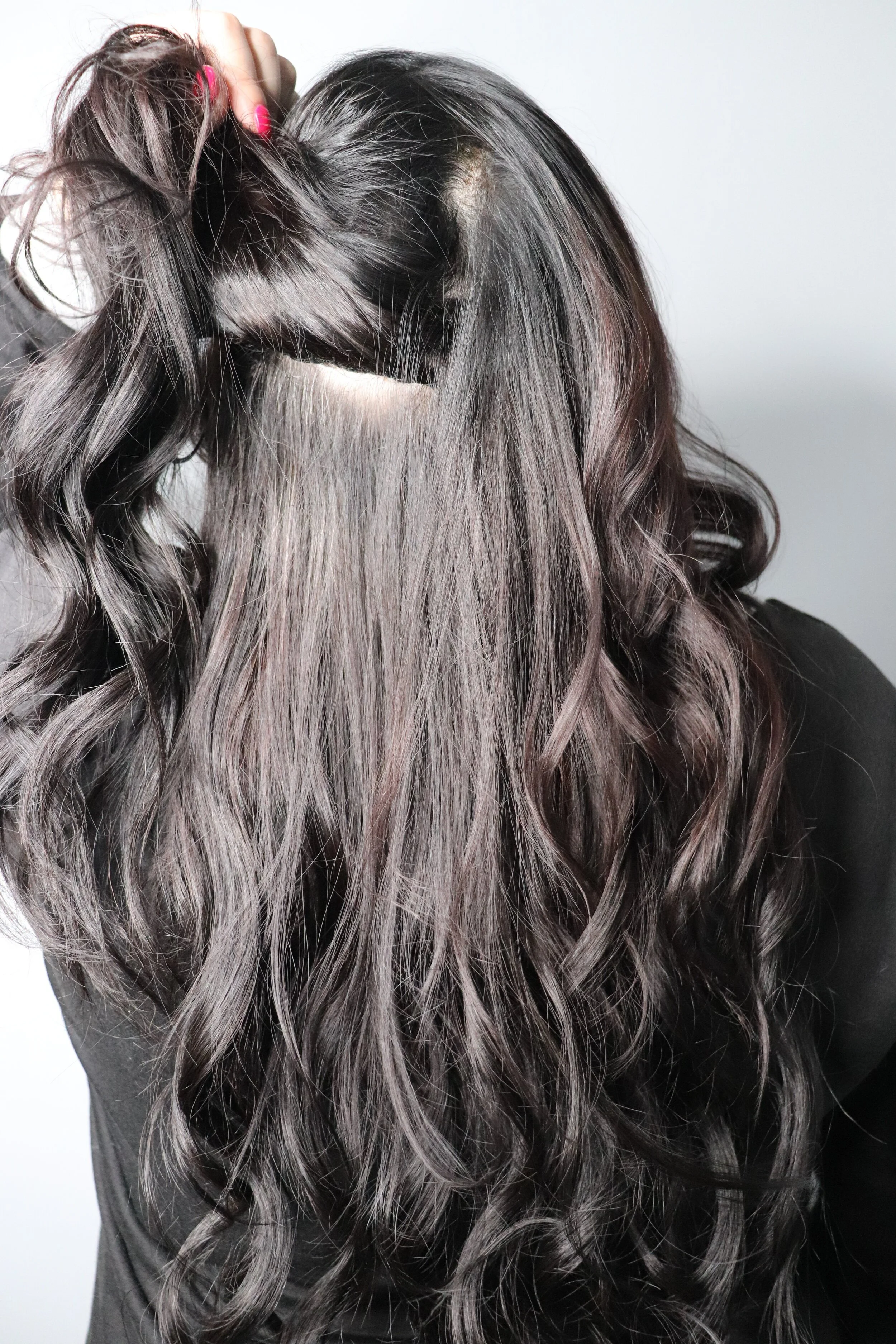 Long dark hair with a hair extension installation at Alfa Jae Salon in Cary, NC