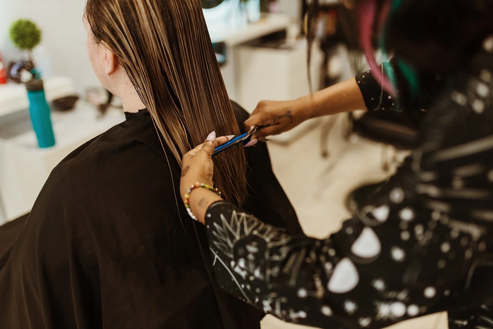 Stylist cutting long hair at Alfa Jae Salon in Cary, NC