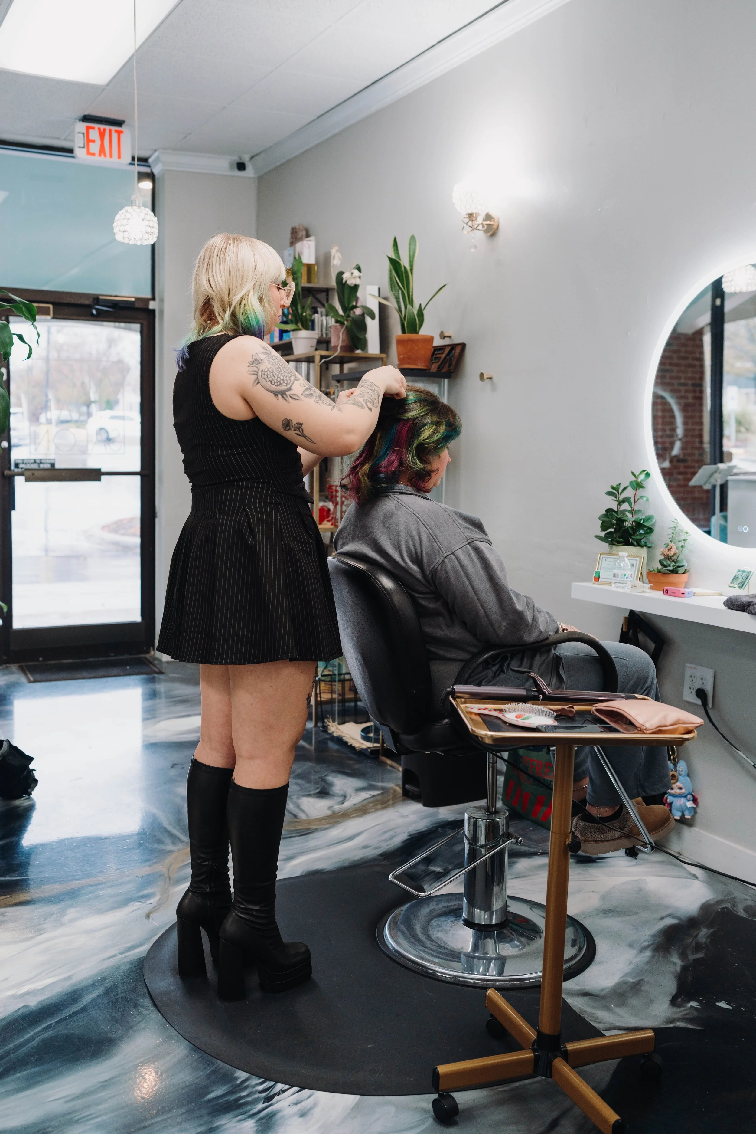 Stylist cutting a guest's hair at Alfa Jae Salon in Cary, NC