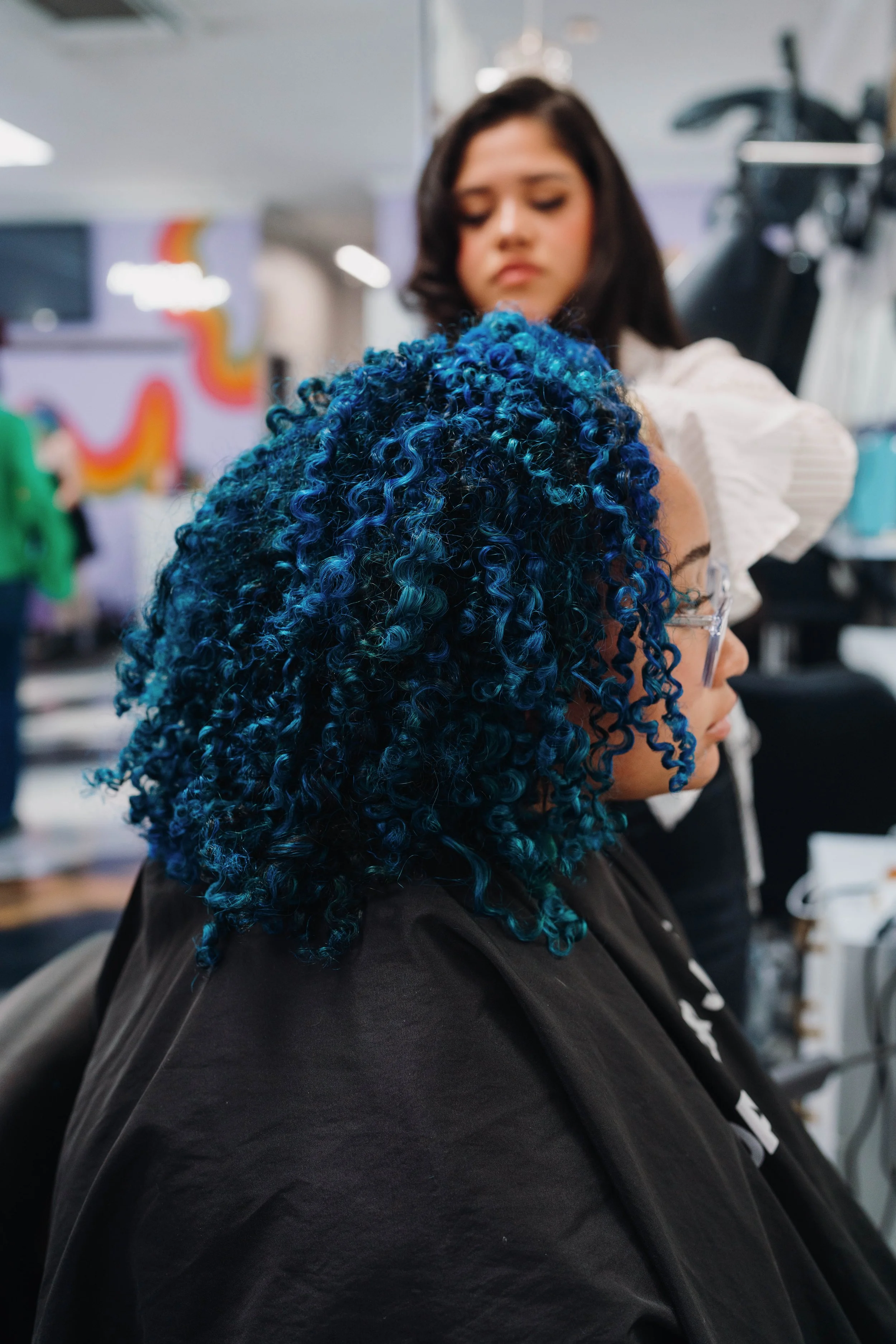 Defined curls with vivid blue hair color at Alfa Jae Salon in Cary, NC