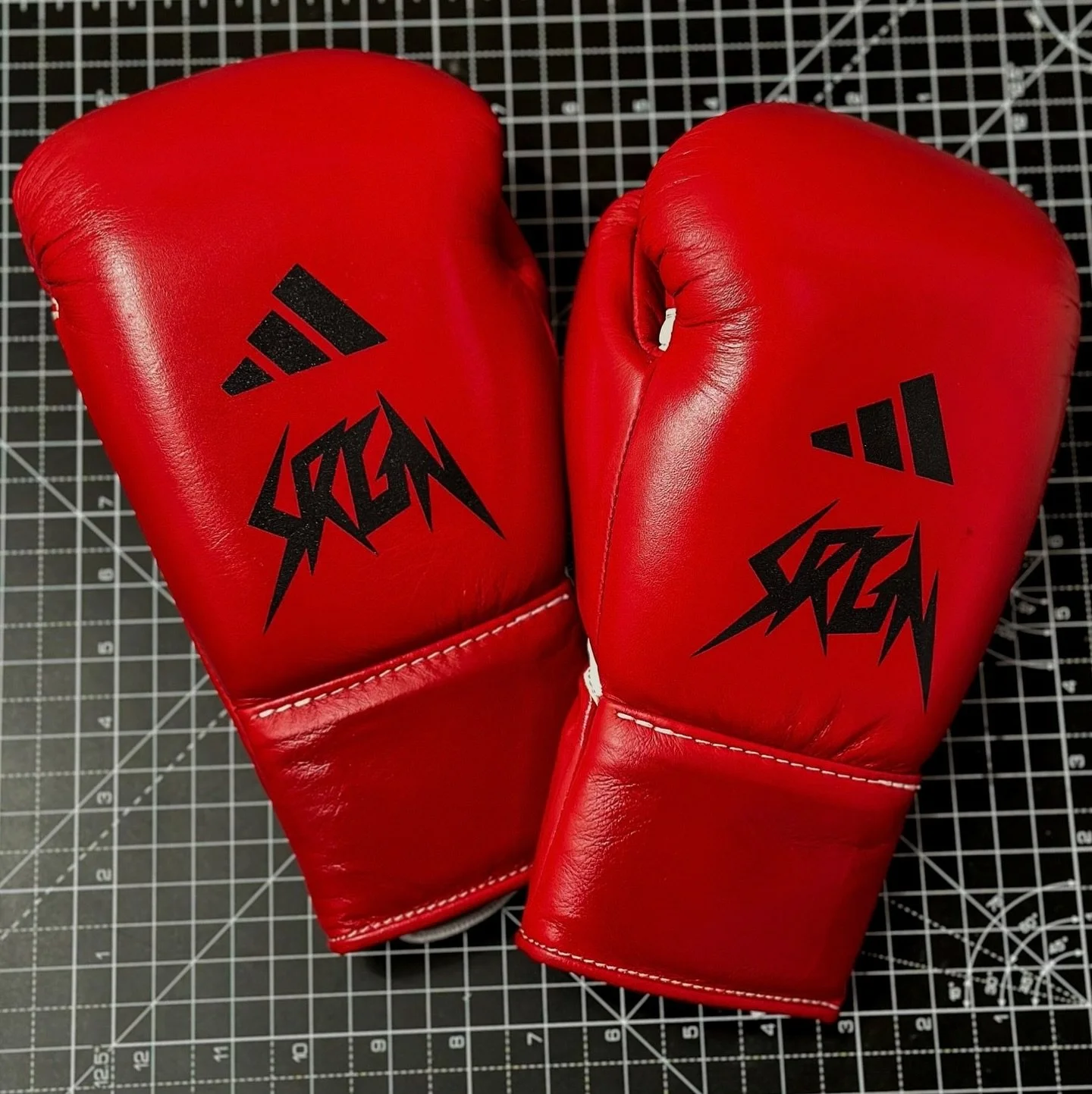 @benwhittaker | Circa 2023
Custom red gloves finished with a metallic black insignia.
Clean placement, no distractions.
Made for the showman.

#ArtOfWarStudio #BenWhittaker #CustomGloves #BoxingGloves #FightGear #BoxingStyle #GloveCustomisation #OneO