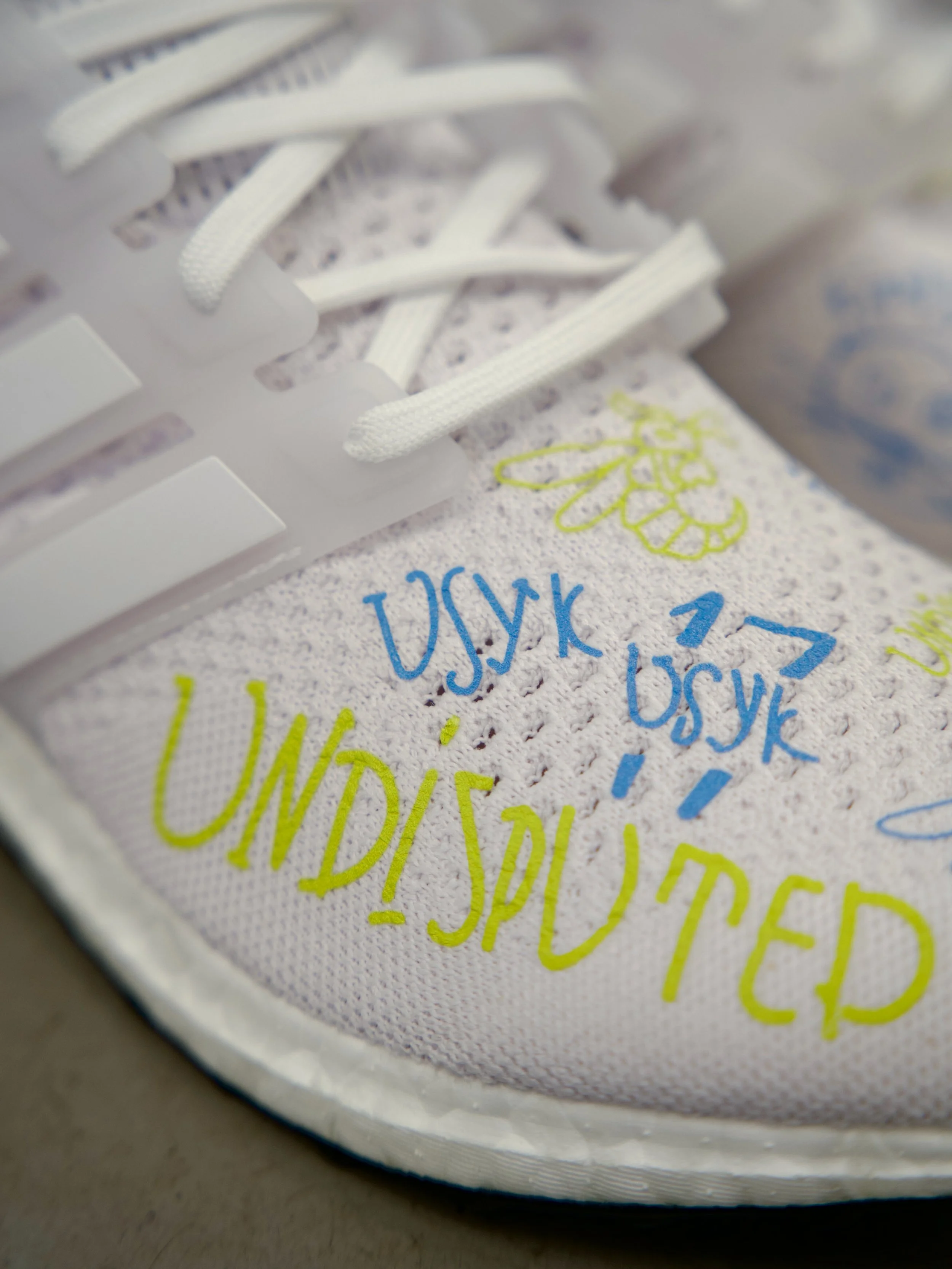 A closer look at the 15 pairs of bespoke Adidas Ultraboosts created for @usykaa and his team 

Each pair was hand finished using layered handwritten detailing throughout the upper, featuring repeated references to &ldquo;Undisputed&rdquo; alongside c