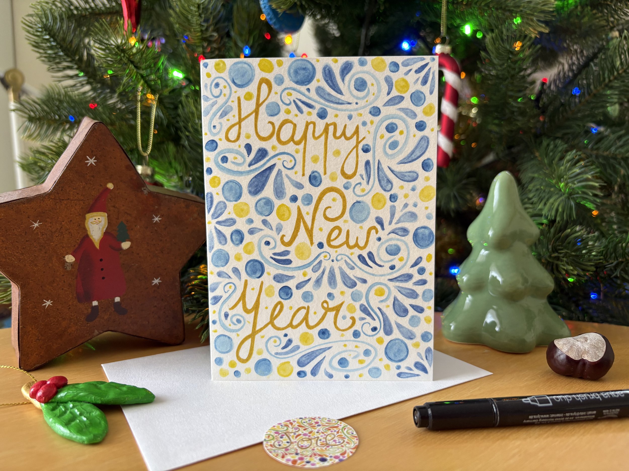 Carte "Happy New Year" avec son enveloppe et son autocollant "Joie"