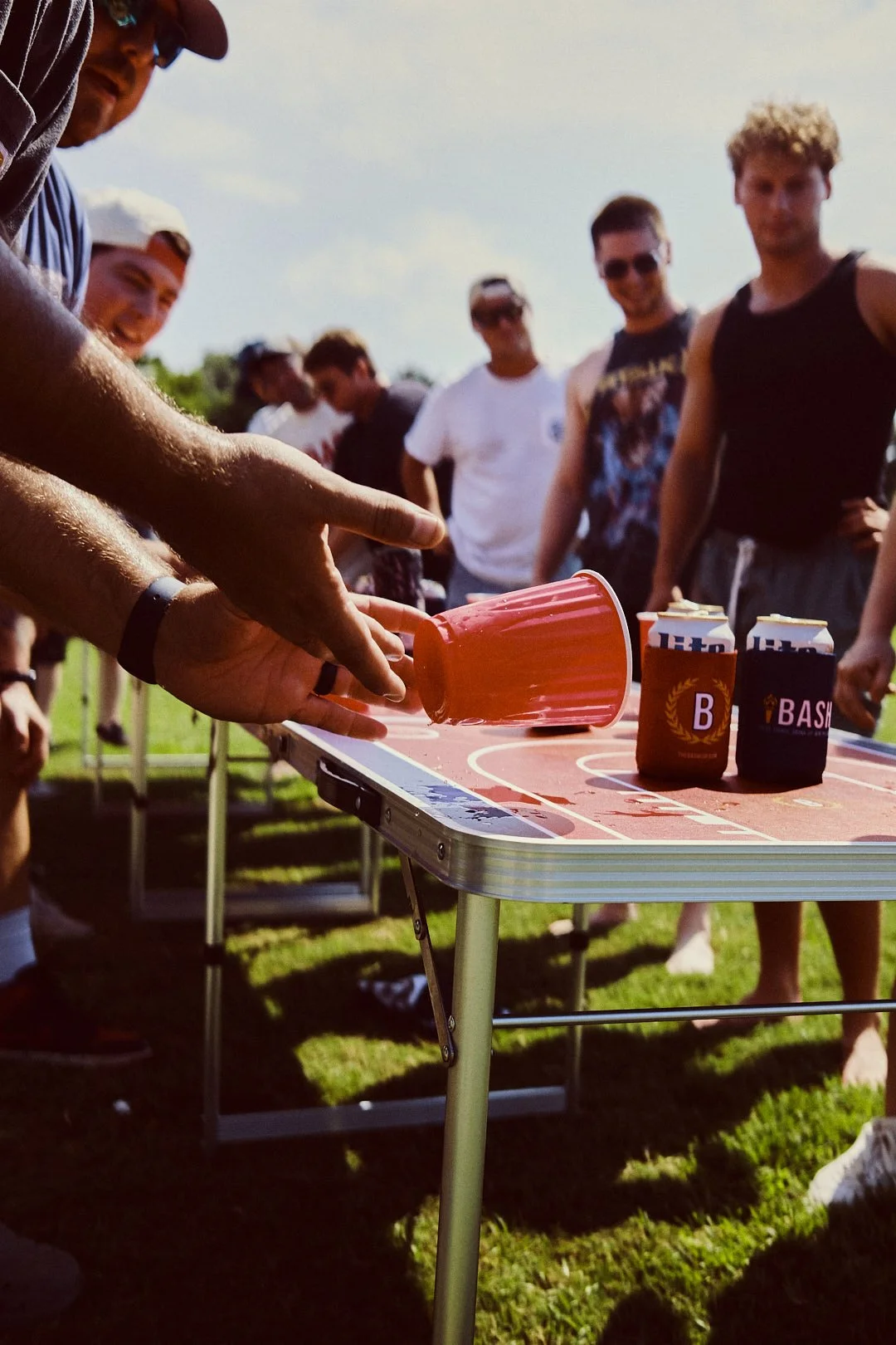 A stylized graphic of a roll of red tape with white lines, attached to a blue background with white and red sections.