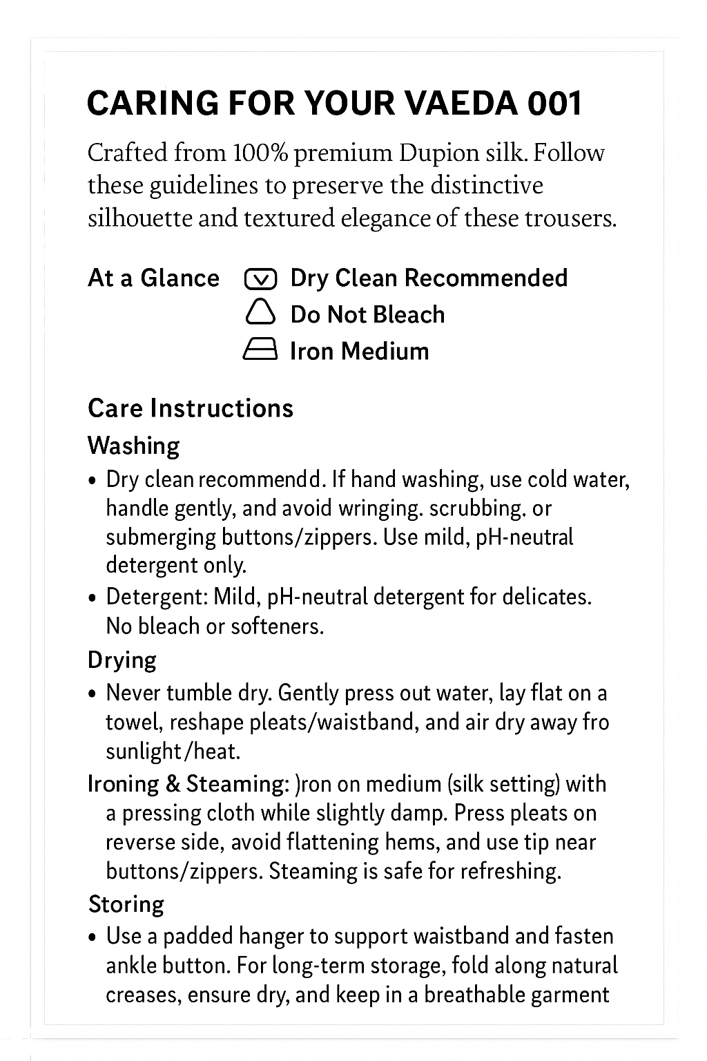 Care instructions for VAEDA 001 trousers, including symbols for dry clean, do not bleach, and iron medium, with detailed washing, drying, ironing, and storing guidelines.