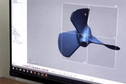 Computer screen displaying a 3D aerodynamic model with a blue and black shape.