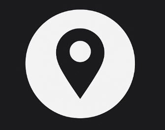 A white location pin icon on a black circular background.