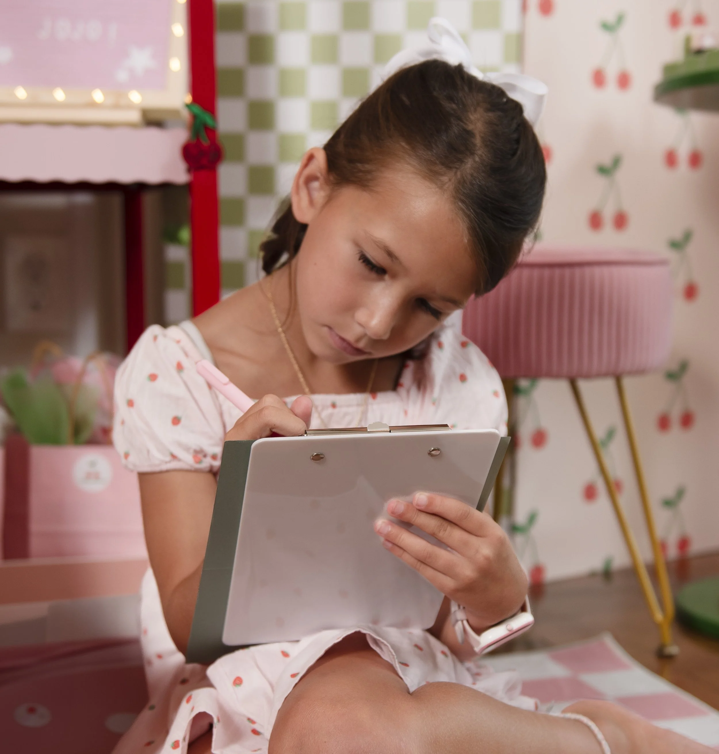 8 year old girl at a veri cheri birthday party writing an affirmation
