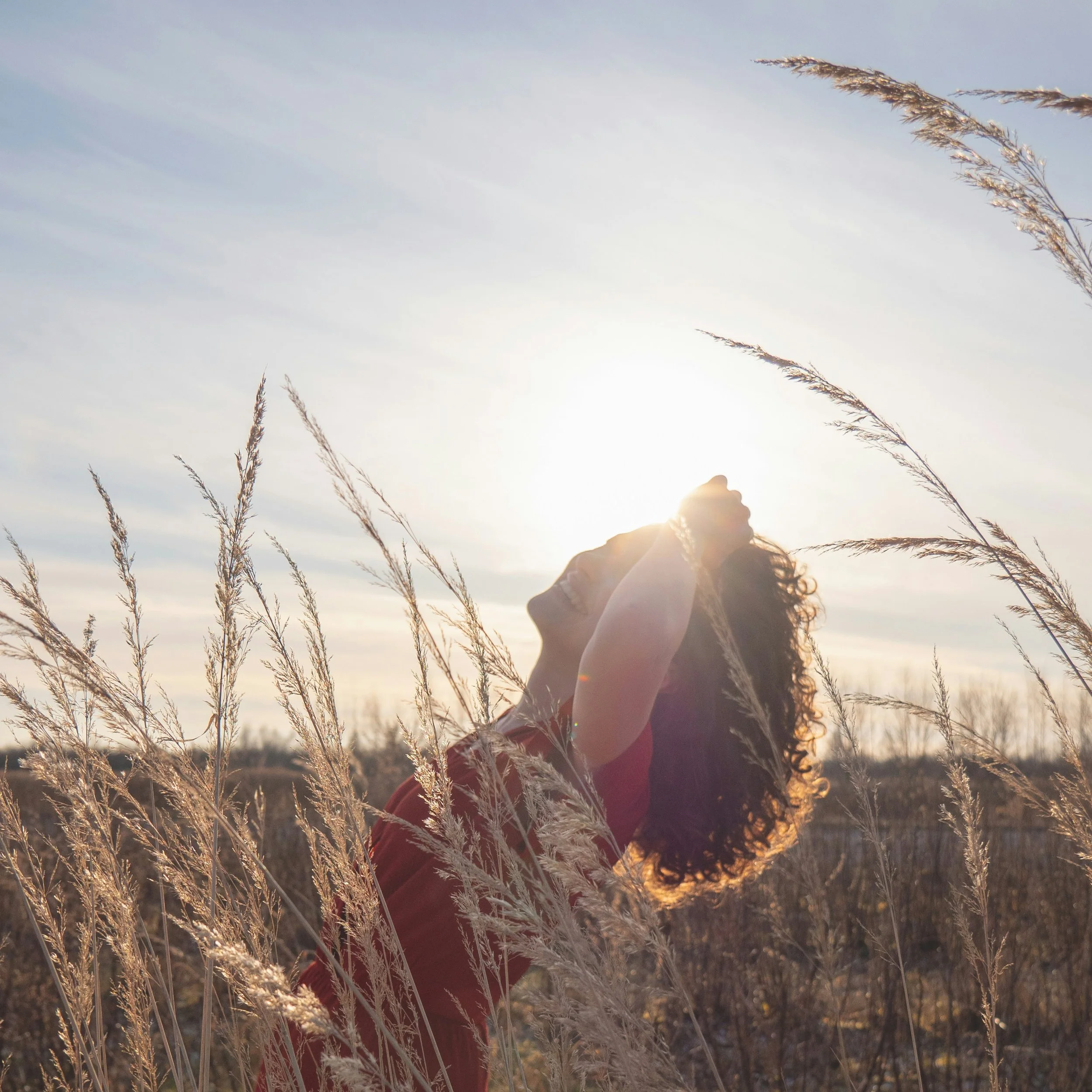 Happy woman in a field, loving life.