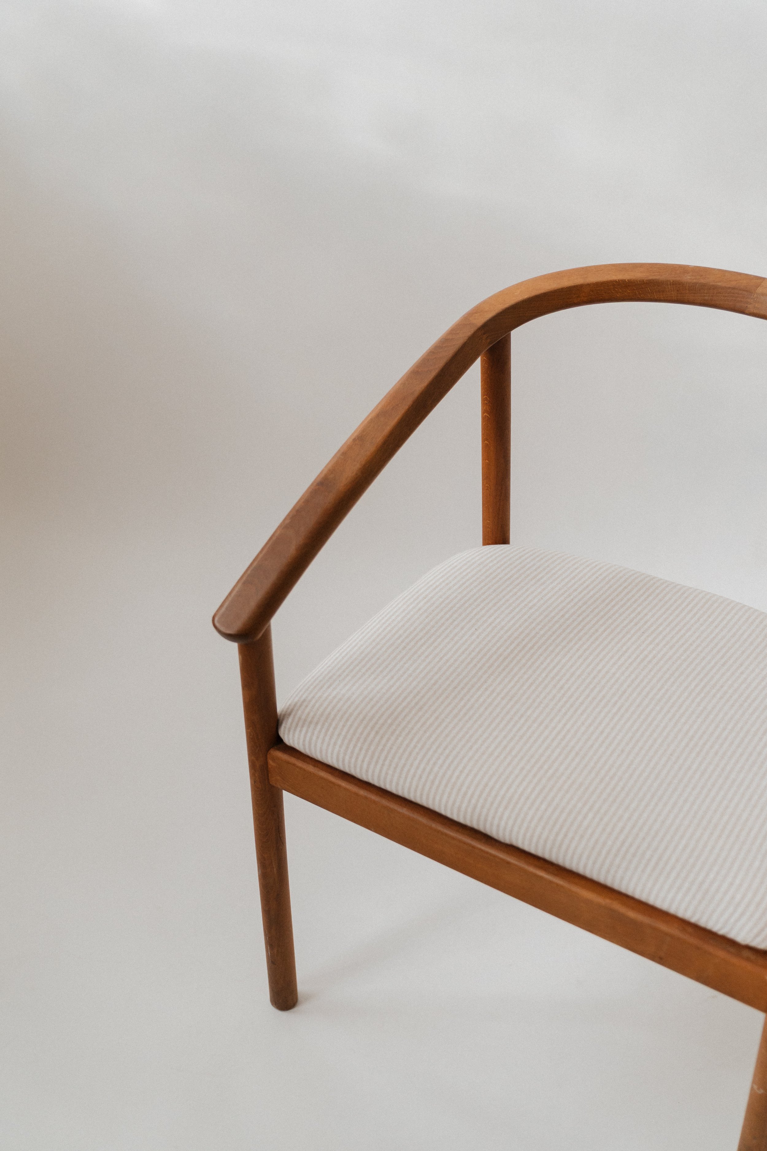 wooden chair arm on neutral backdrop Grand Rapids photo studio