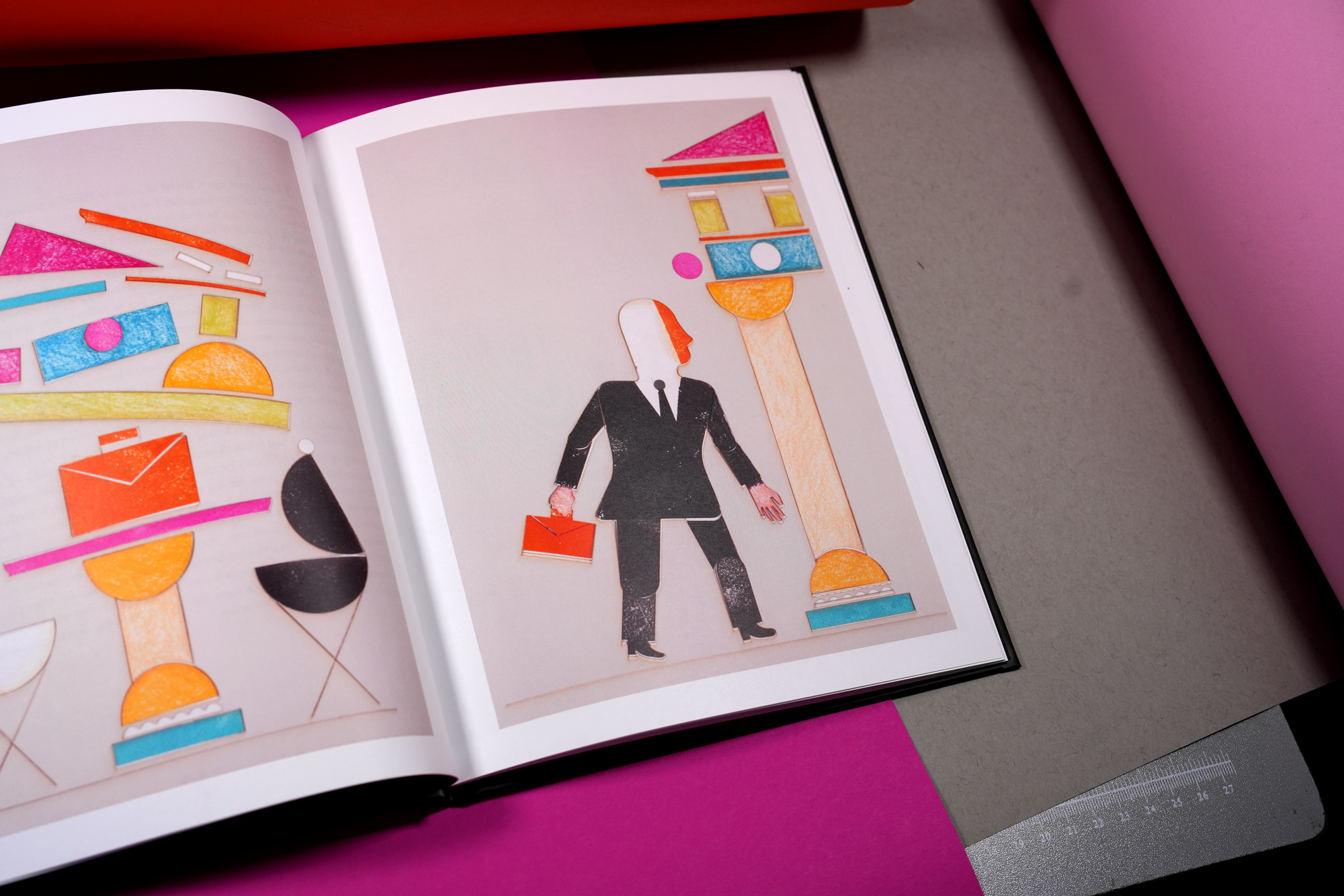 Open magazine displaying a collage of geometric shapes forming a businesswoman carrying a briefcase, surrounded by colorful abstract columns and shapes.