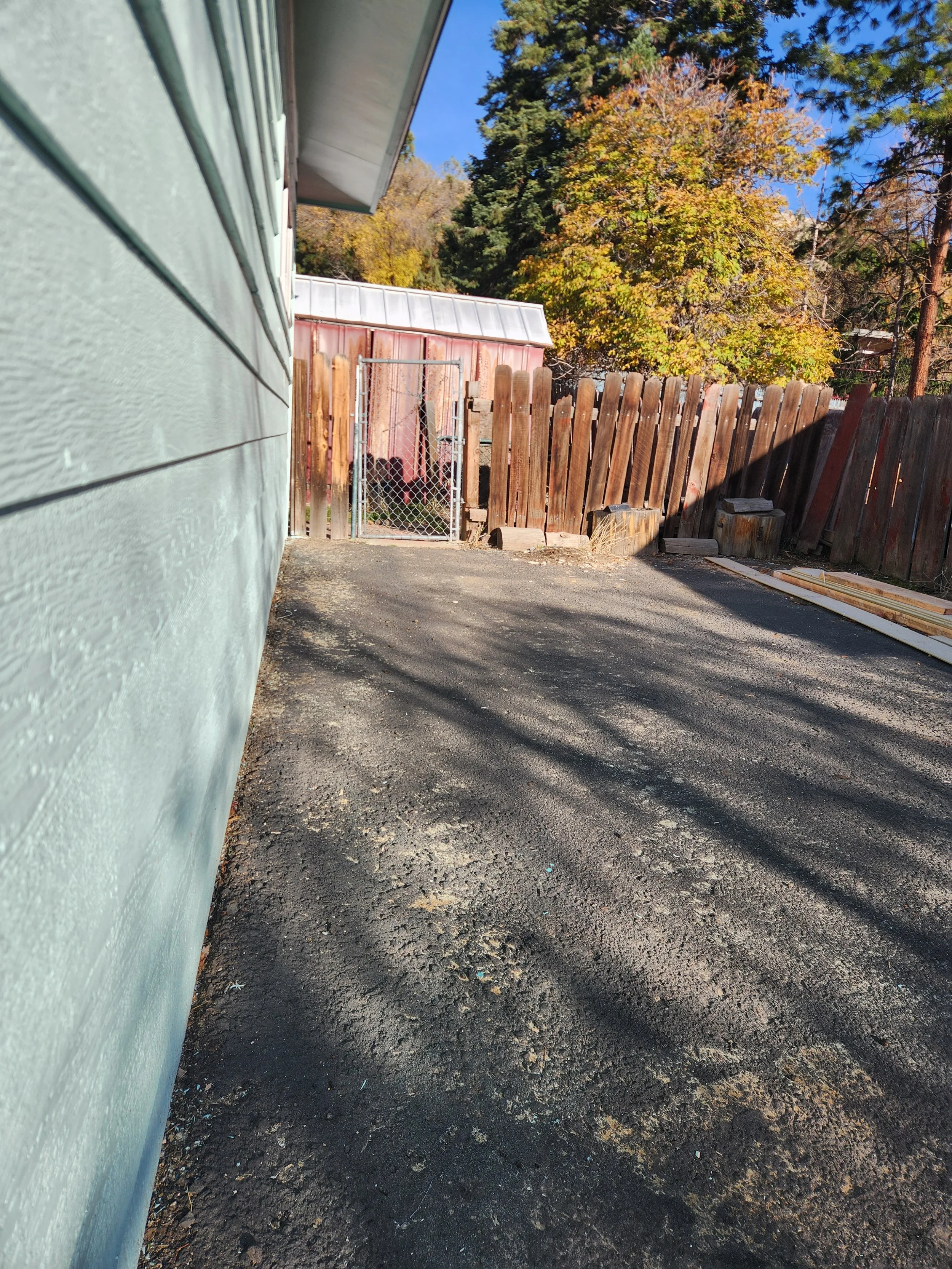 Front view of a two-story, blue house with an attached garage and a neatly maintained lawn