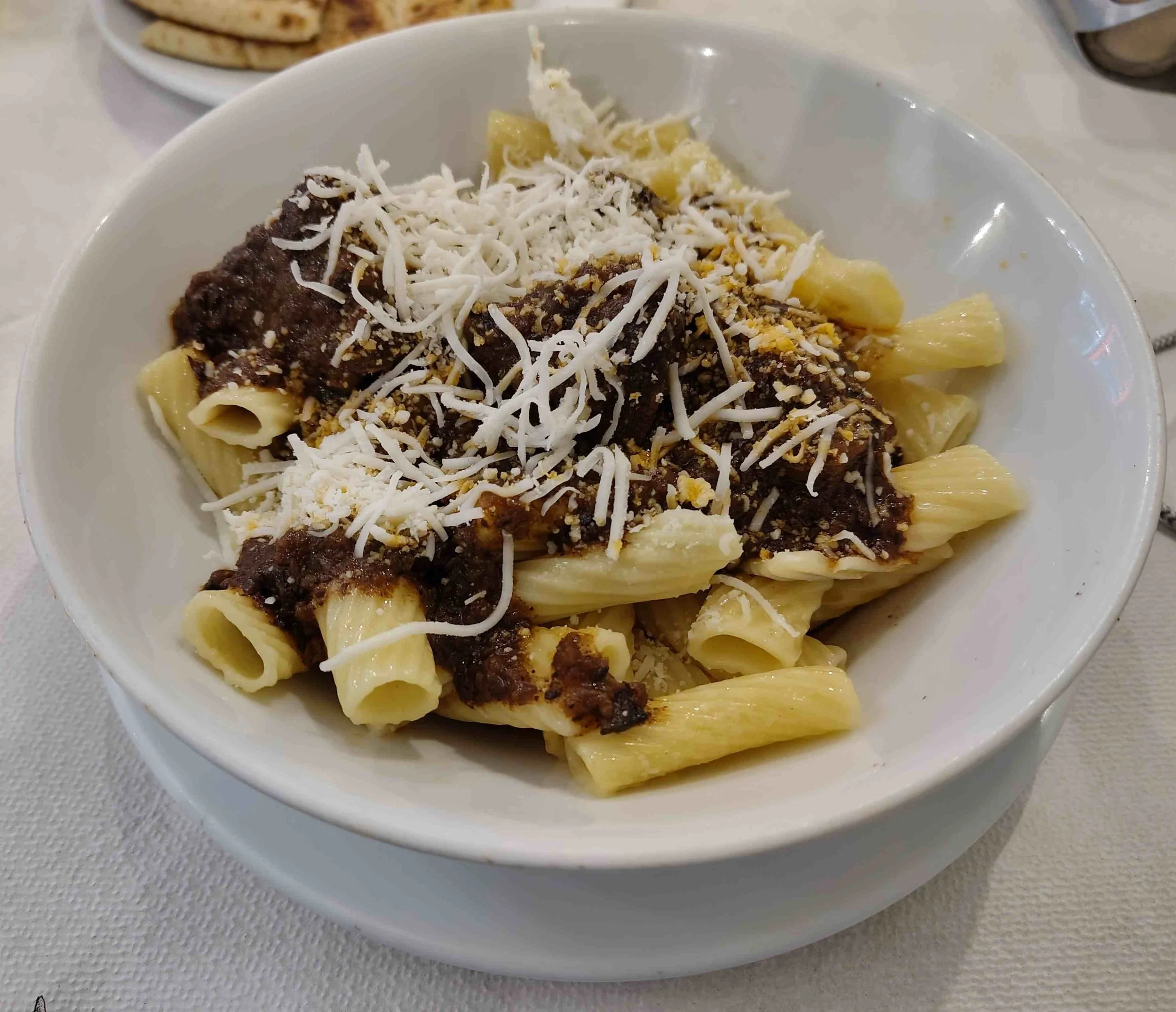 Greek pastitsada, beef in tomato and spice sauce served over pasta with cheese