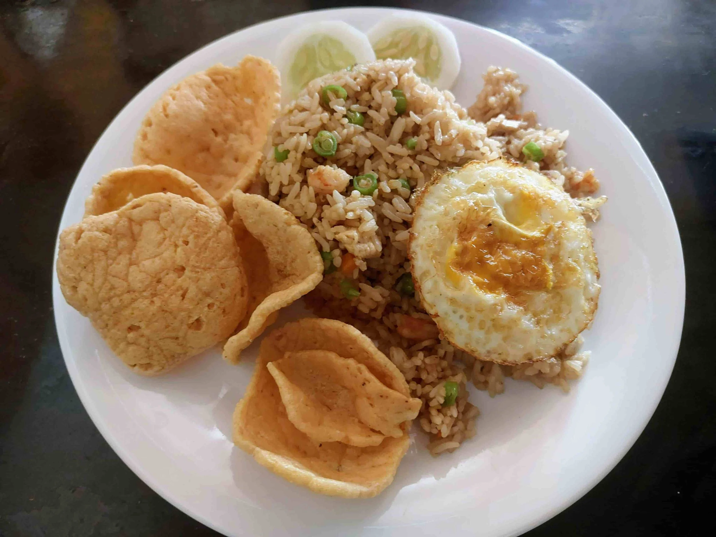 Traditional Indonesian Nasi Goreng – fried rice topped with a fried egg and crispy crackers