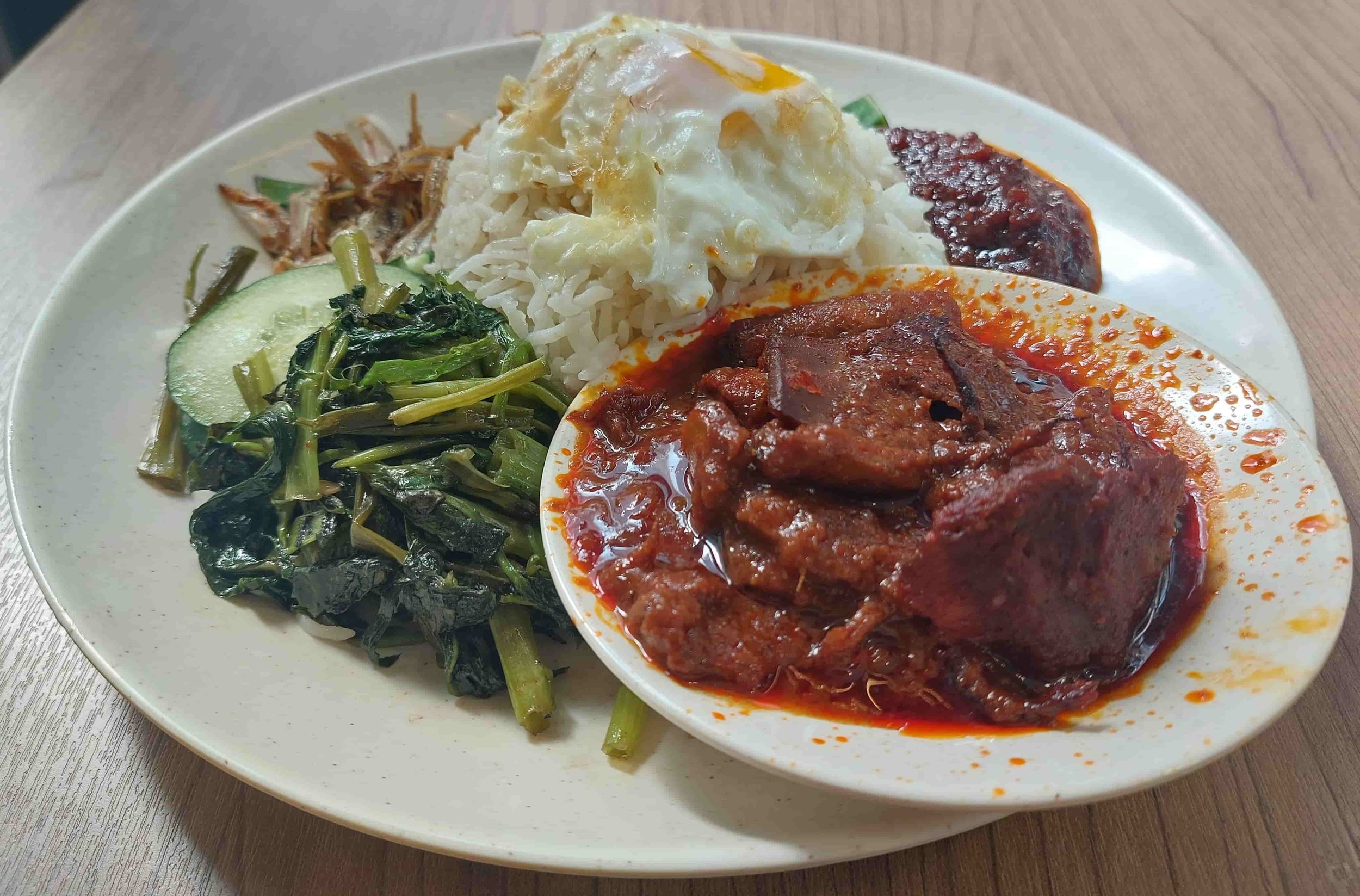 Sambal sotong – spicy Malaysian squid in chilli sauce served with fried rice and greens