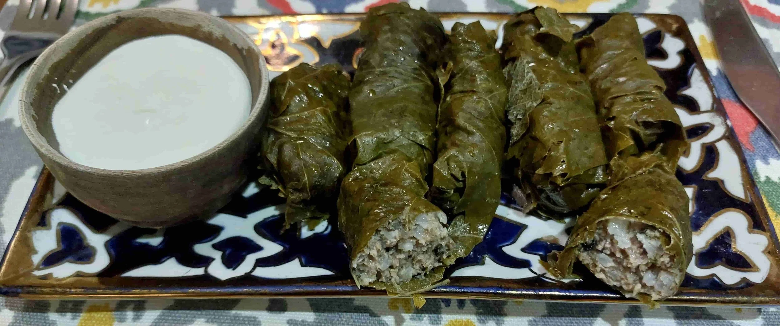 Uzbek dolma stuffed grape leaves with rice and minced meat traditional dish