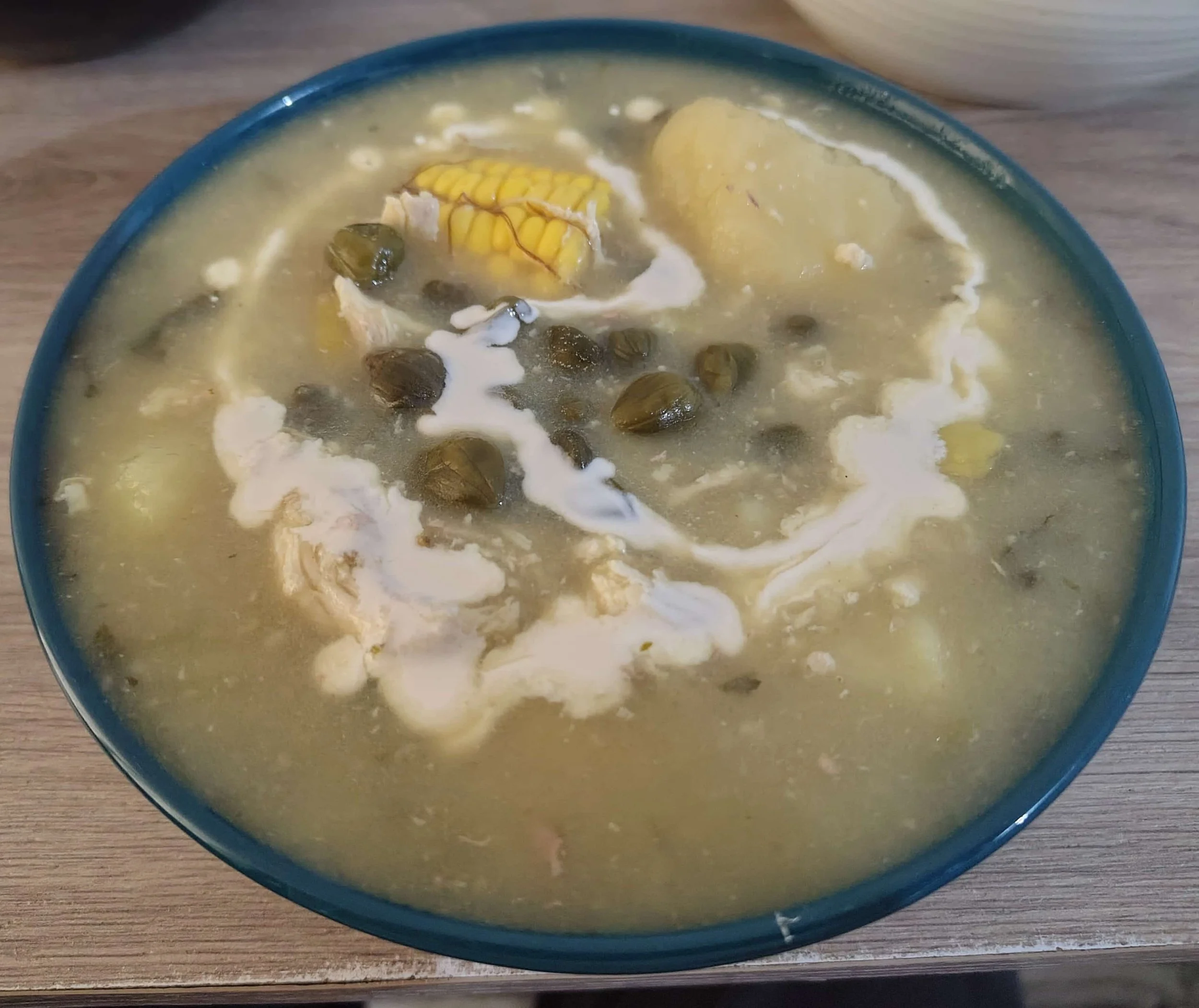 Colombian ajiaco – chicken and potato soup with corn on the cob, capers, and herbs