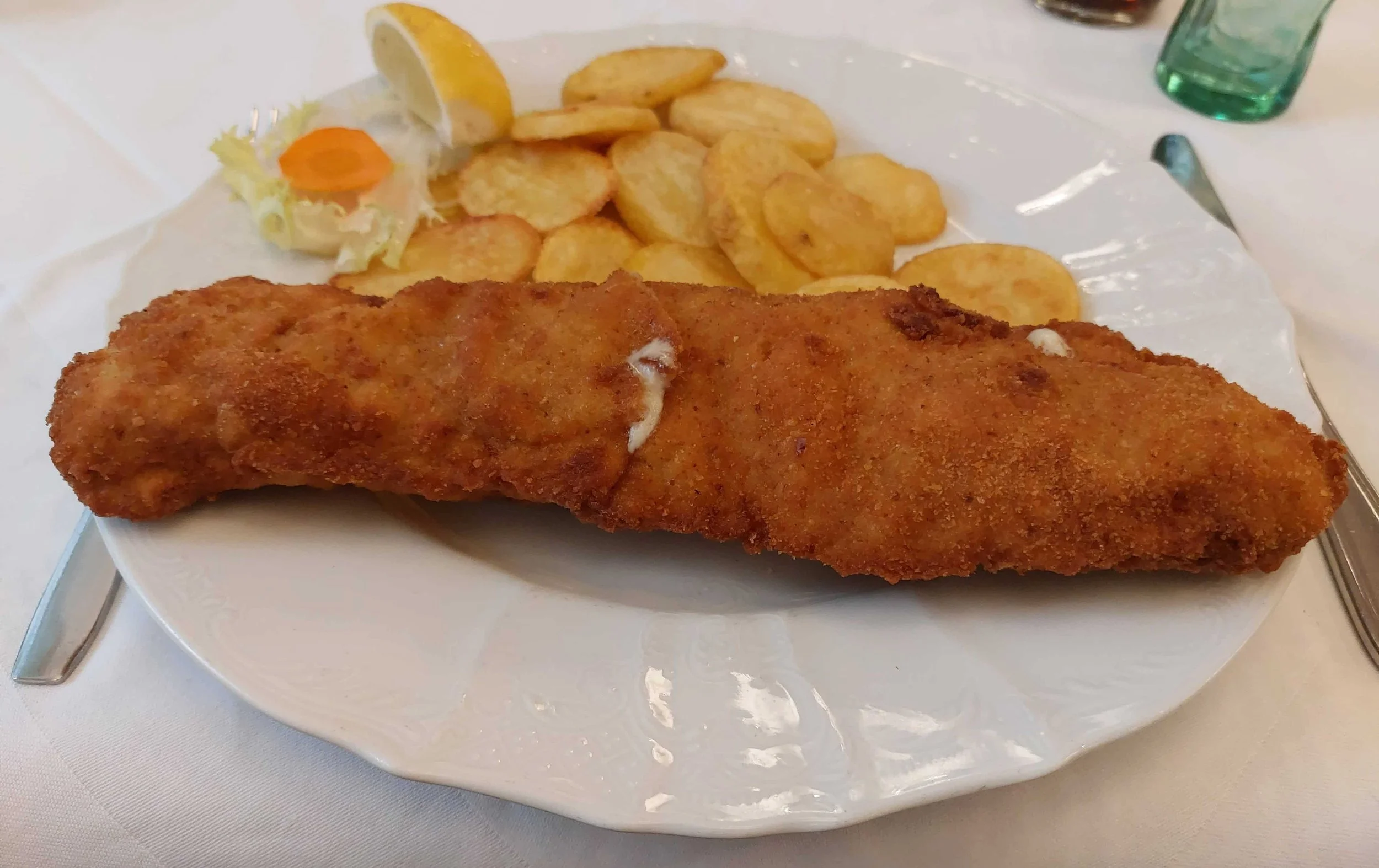 Zagrebački odrezak – Croatian breaded veal schnitzel served with fried potatoes and a wedge of lemon