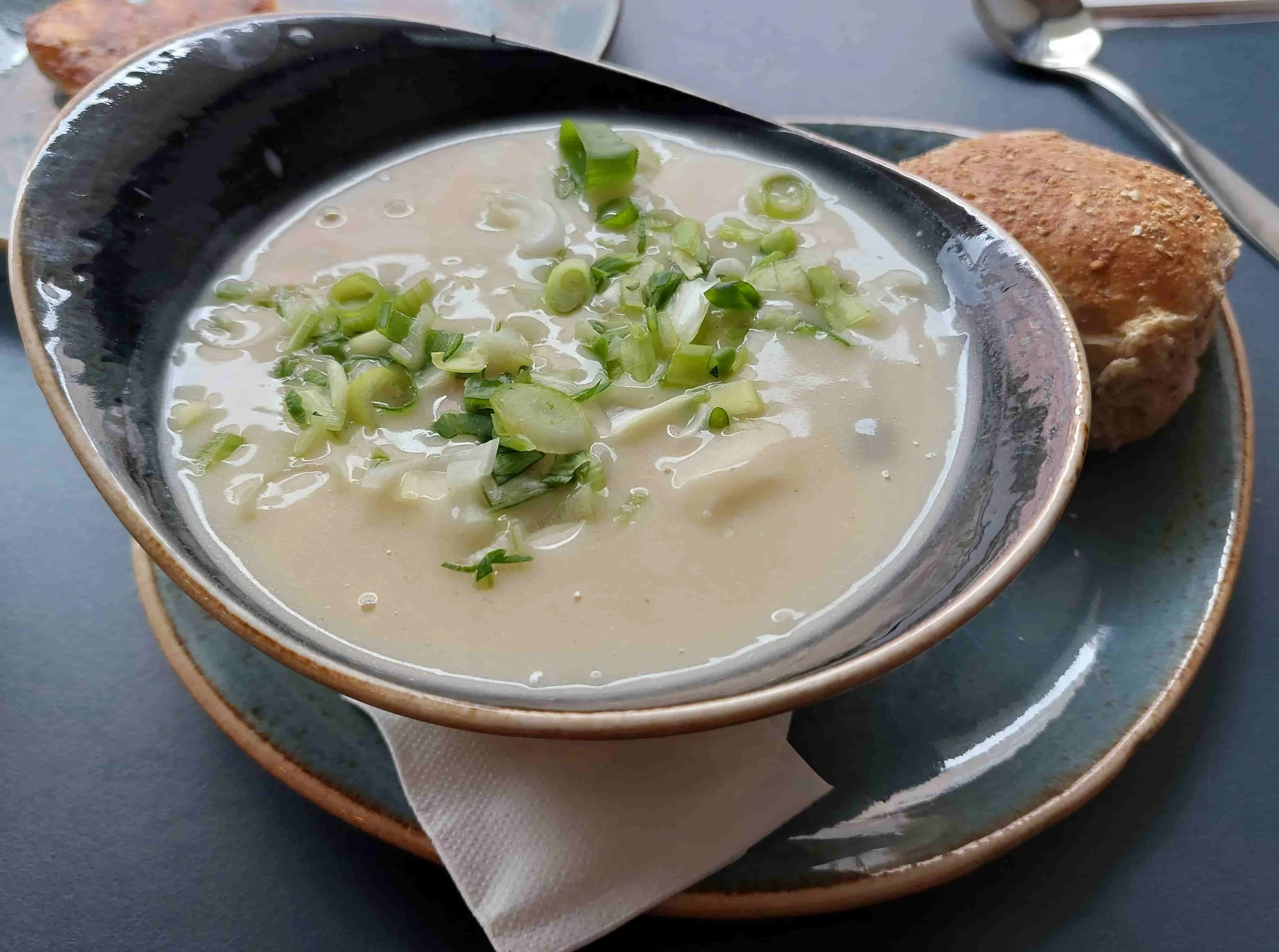 Traditional Norwegian Bergensk fiskesuppe – creamy fish soup with chunks of cod, shrimp, carrots, leeks, and fresh herbs
