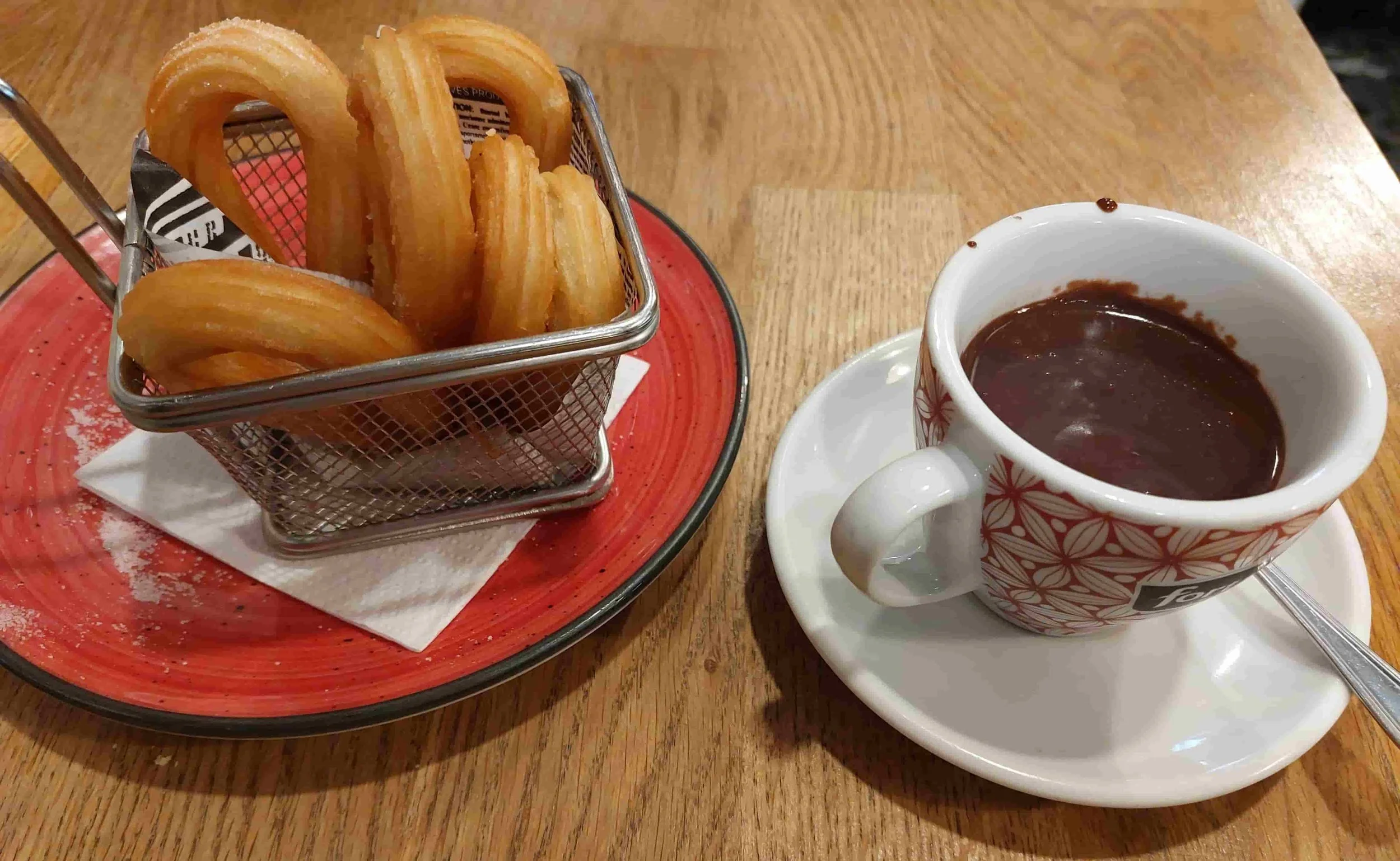 Spanish chocolate con churros crispy fried dough served with thick hot chocolate