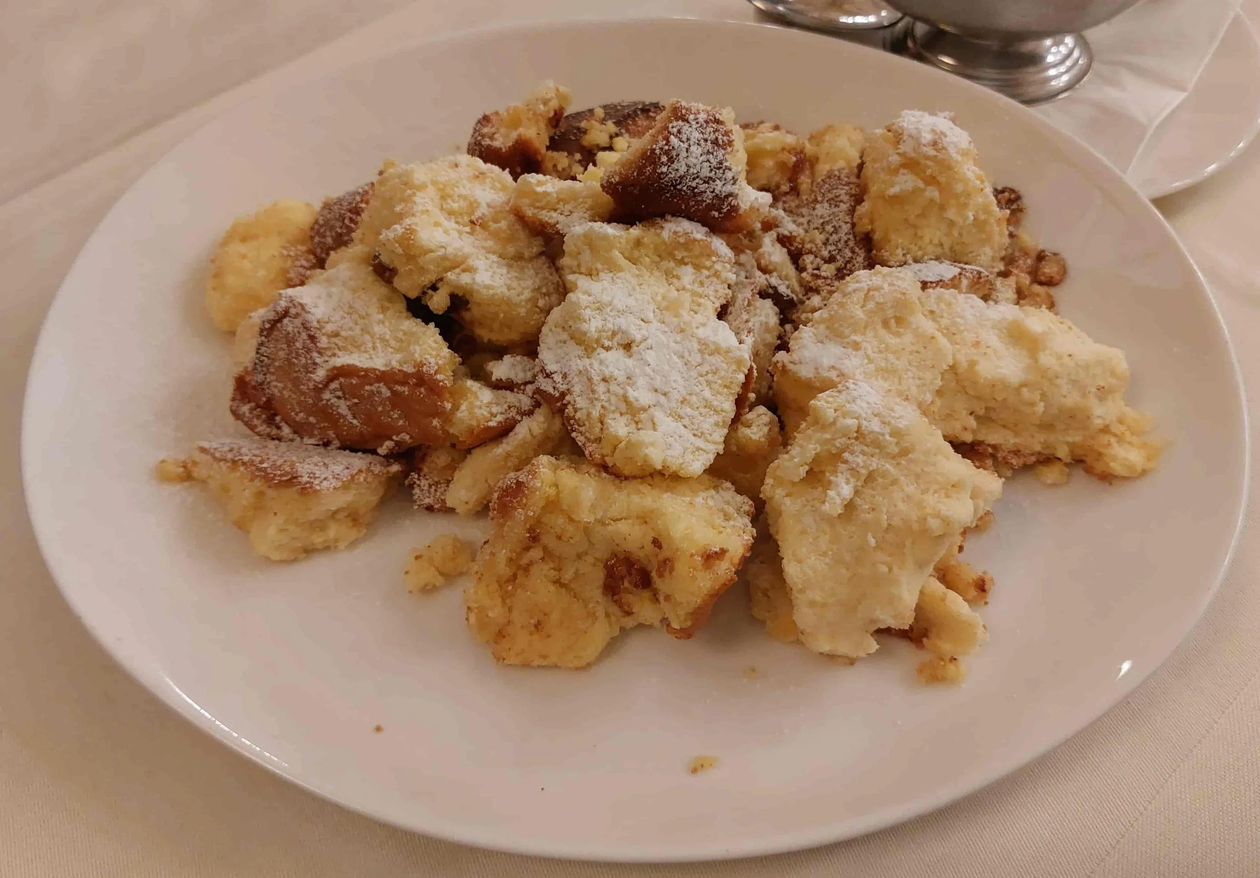 Kaiserschmarrn fluffy shredded pancake dessert with powdered sugar