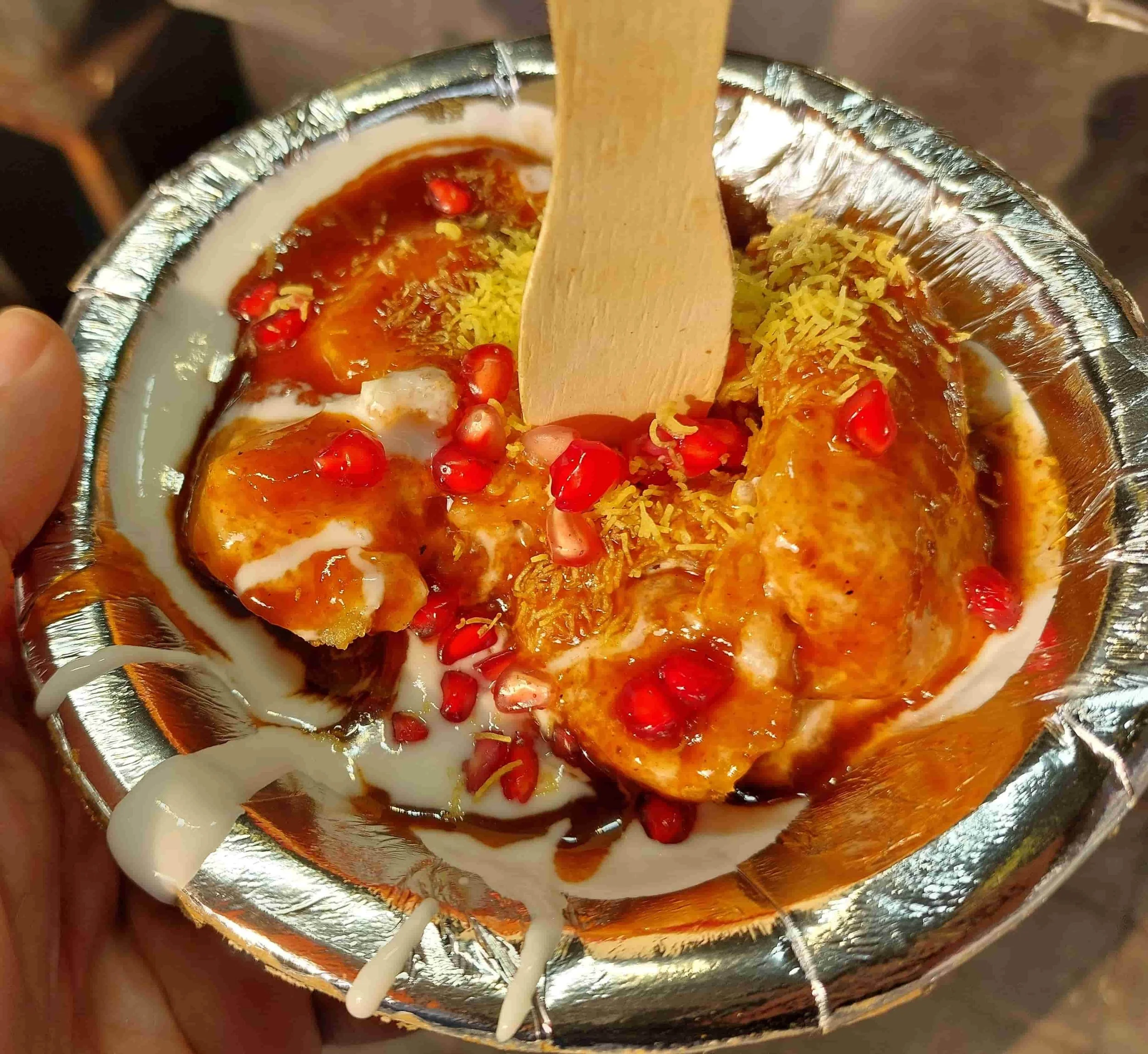Aloo tikki – Indian potato patties topped with yoghurt, pomegranate seeds, and chutneys