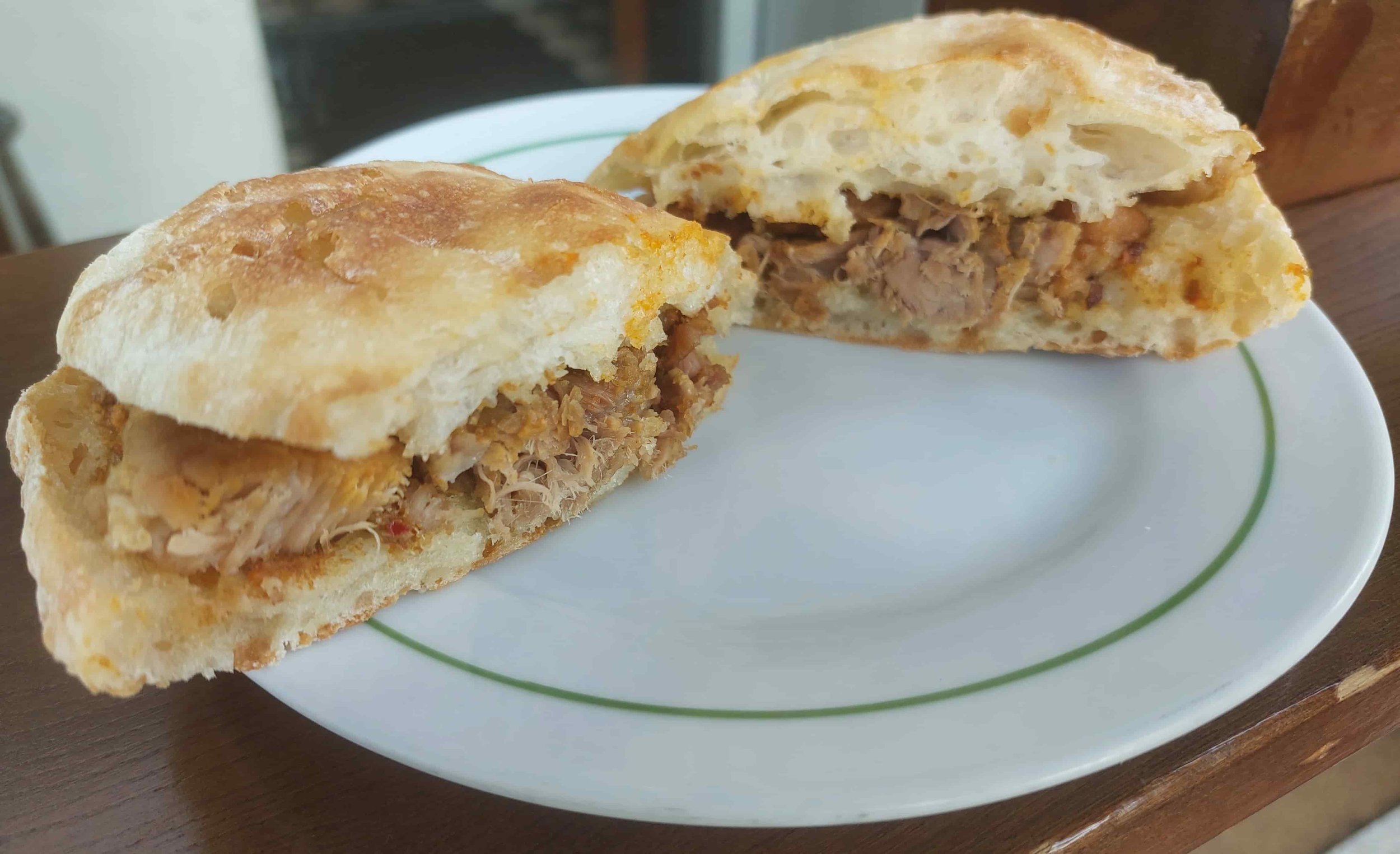 Portuguese Rojões marinated pork chunks served in a bread roll