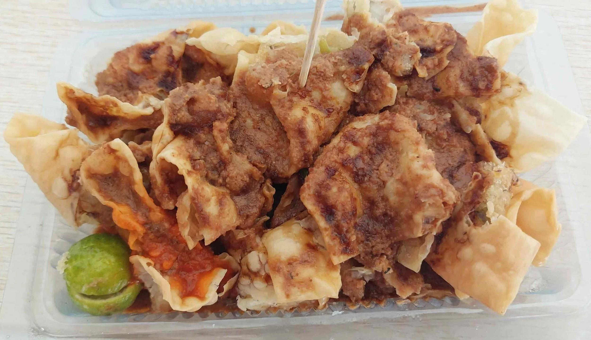 Batagor, Indonesian street food featuring fried fish dumplings and savory peanut sauce