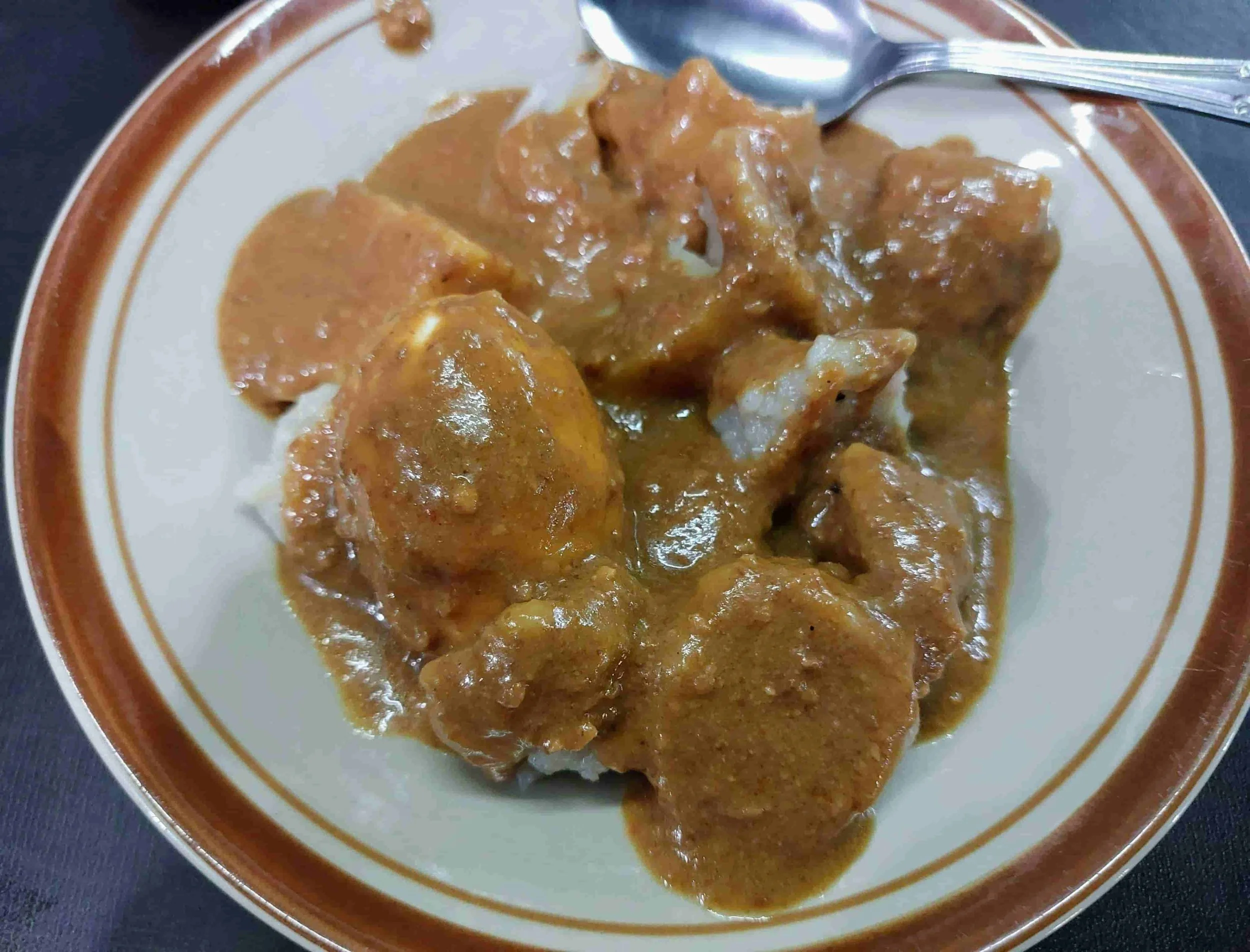 Indonesian siomay steamed fish dumplings served with potato, cabbage, tofu, and topped with peanut sauce and chili