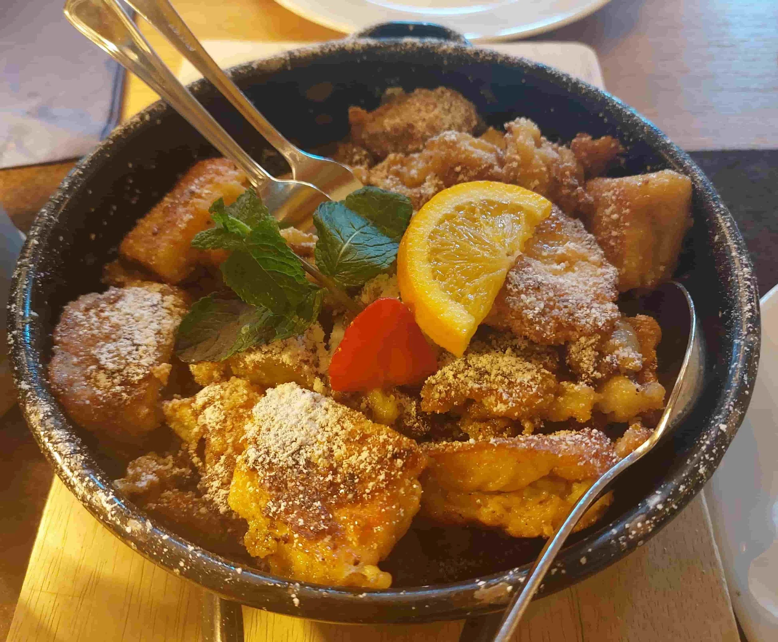 Kaiserschmarrn fluffy shredded pancake dessert with powdered sugar