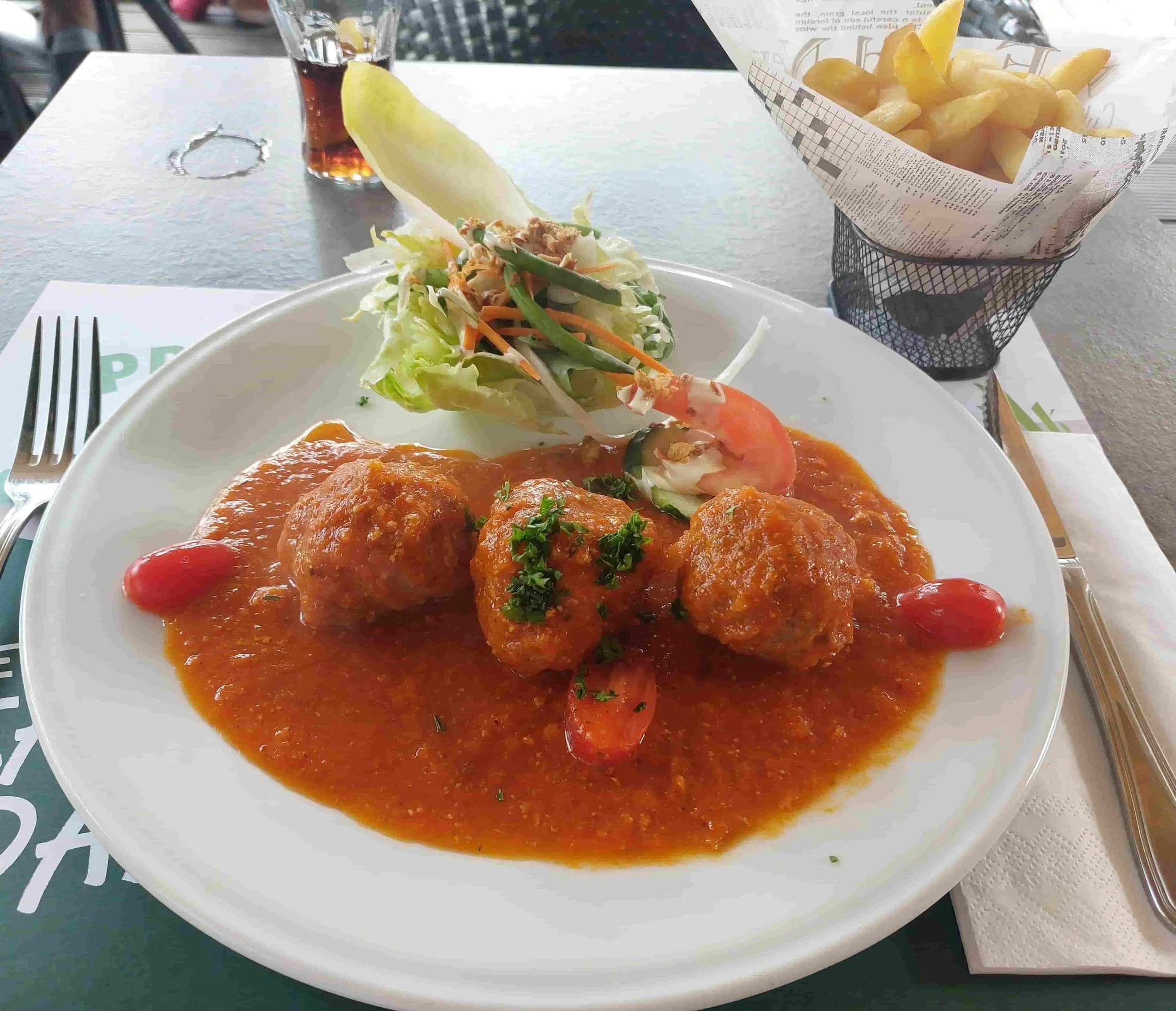 Belgian boulettes meatballs in tomato sauce served with salad and fries