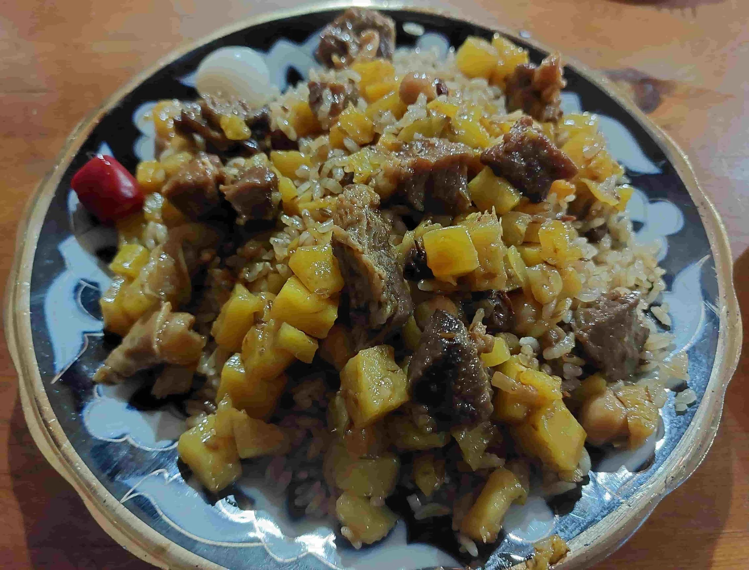 Uzbek plov traditional rice dish with lamb, carrots, and onions