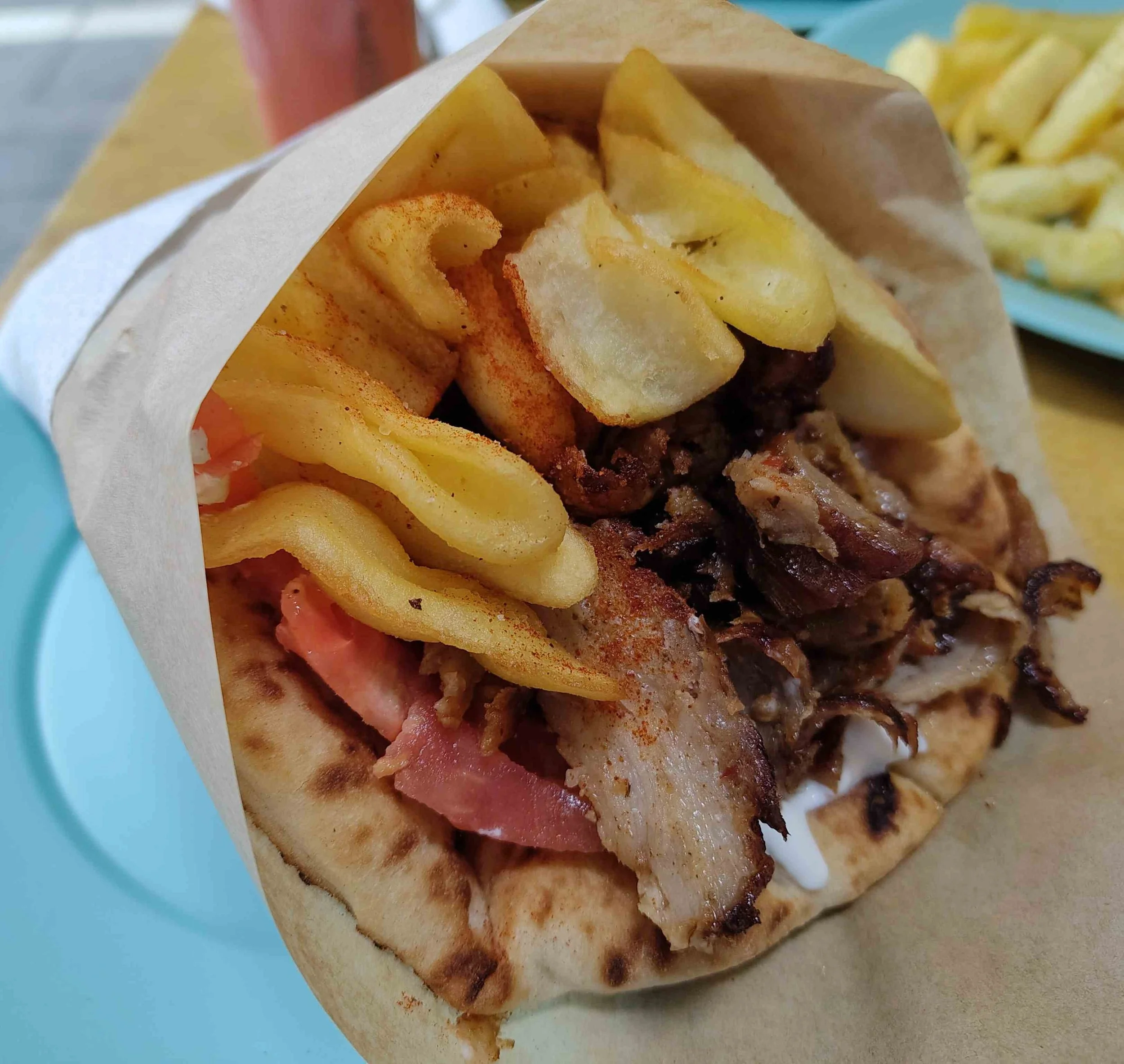 Gyros – Greek wrap with sliced pork, tomatoes, onions, fries and tzatziki