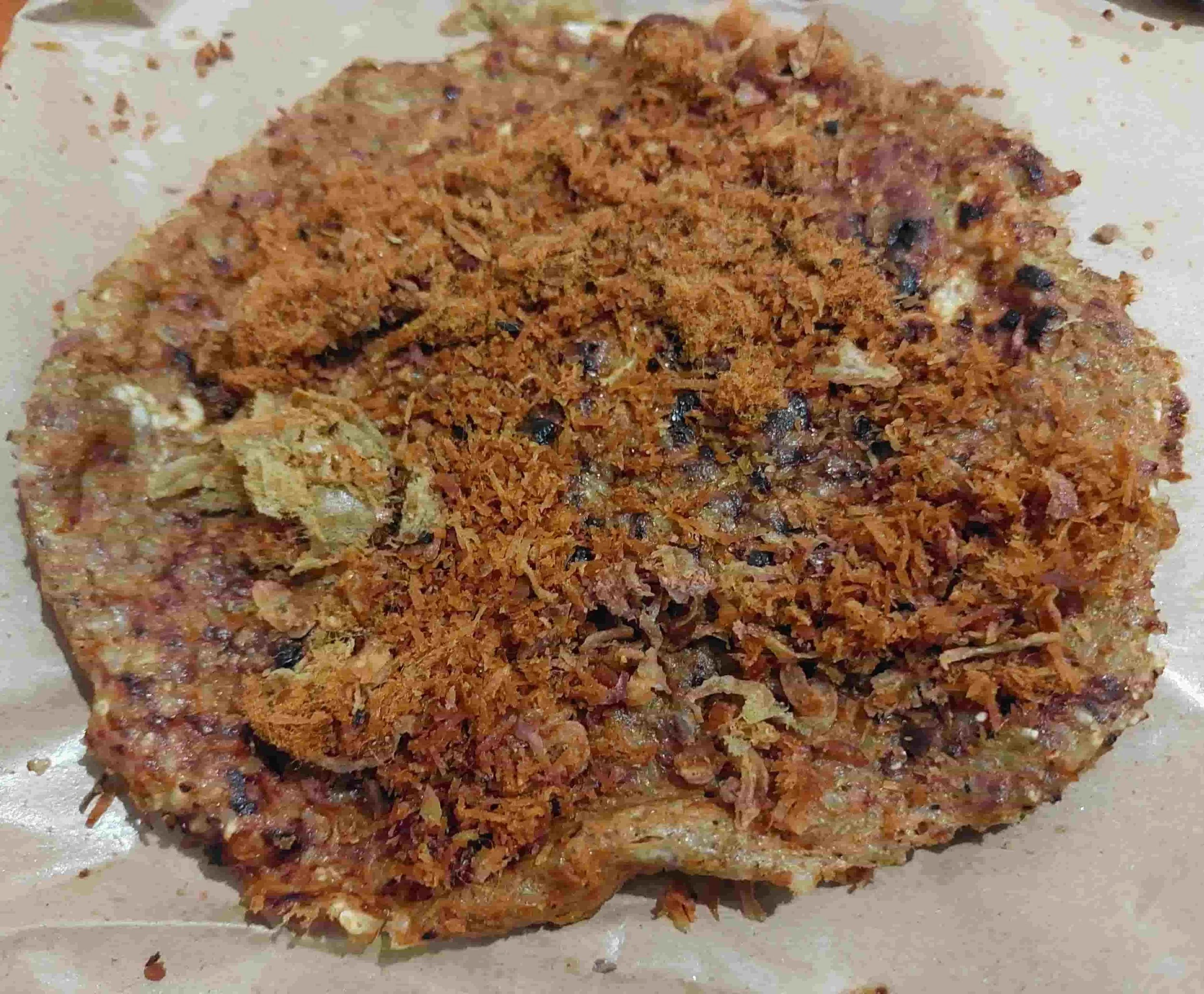 Indonesian Kerak Telor snack made from sticky rice, egg, and spicy toppings