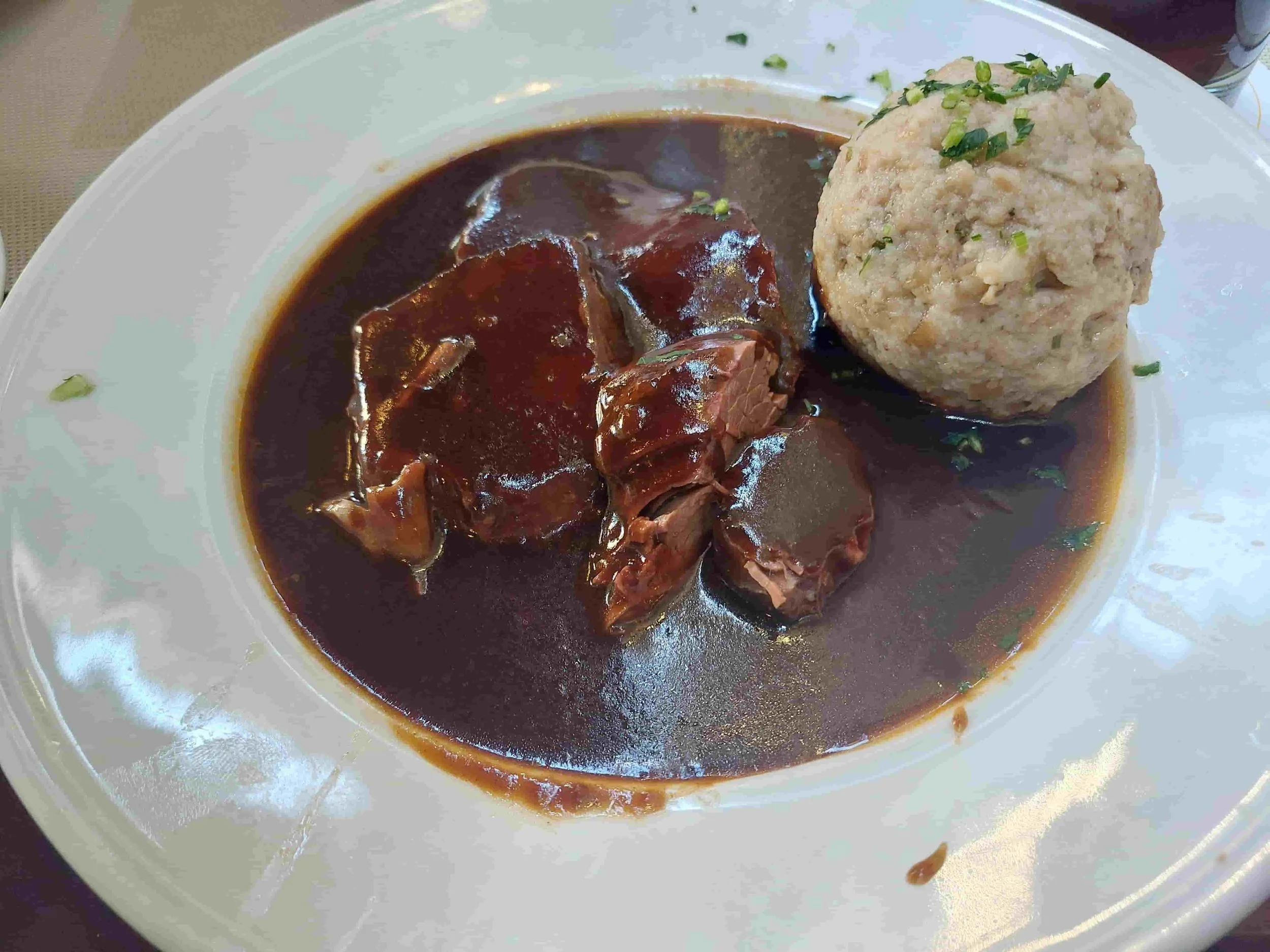 German Sauerbraten marinated pot roast with traditional bread dumpling and gravy
