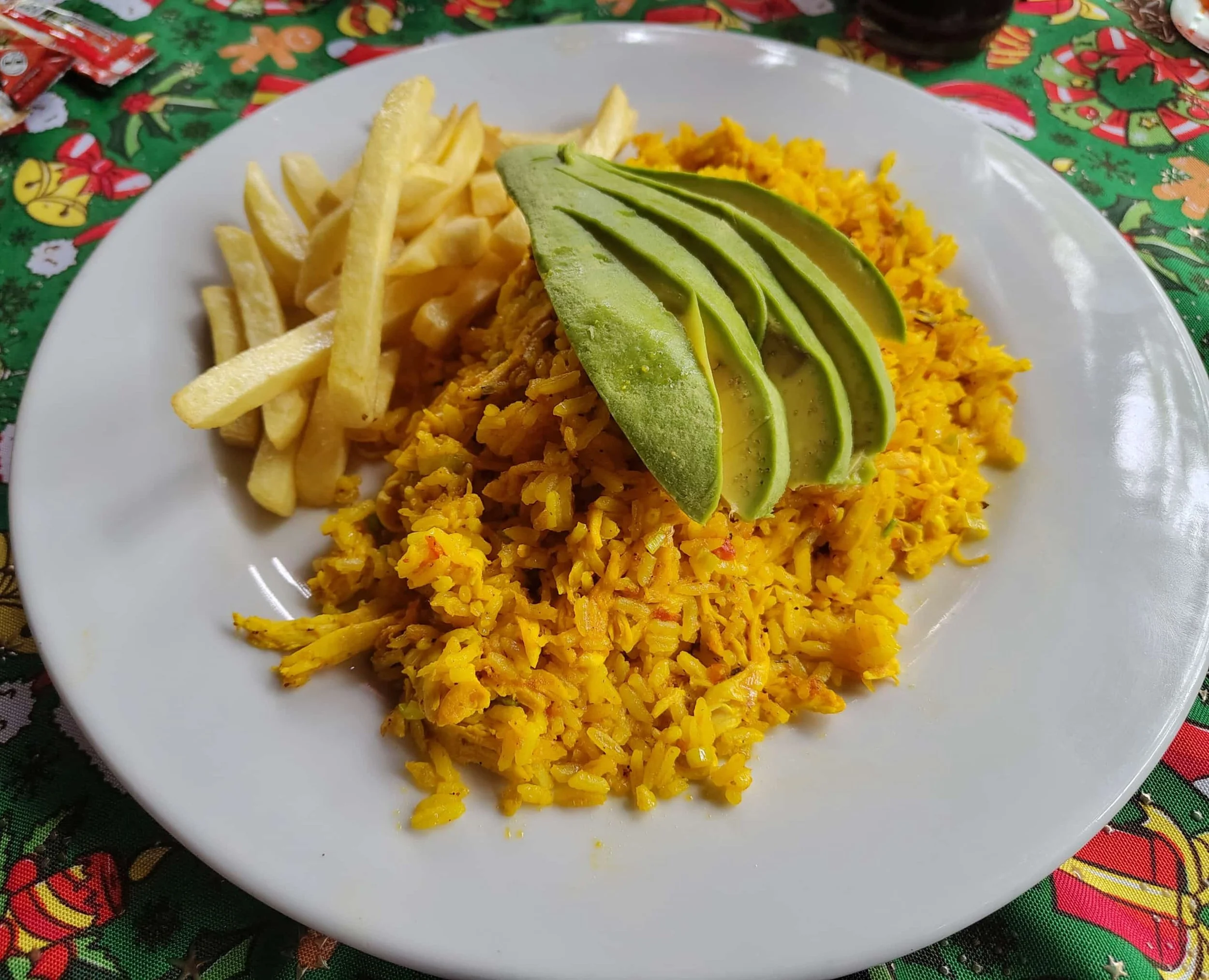 Arroz con pollo – Colombian shredded chicken and rice served with fries and avocado
