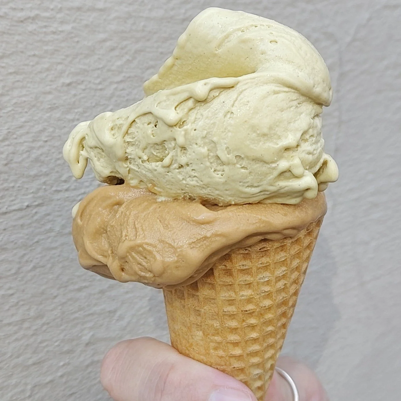Italian gelato in a cone with coffee and pistachio flavours