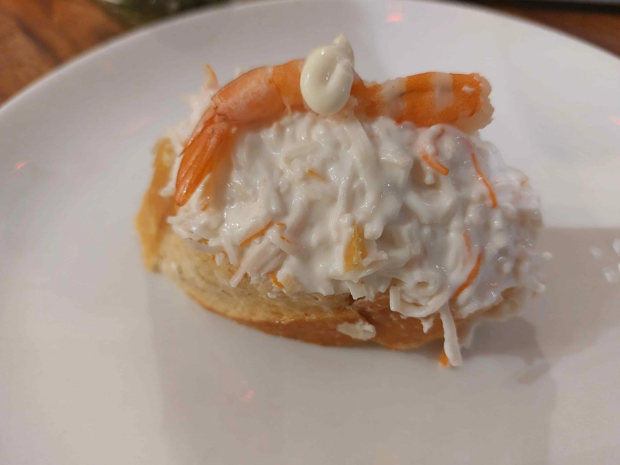 Basque txaka pintxo imitation crab with mayonnaise and prawn on bread slice