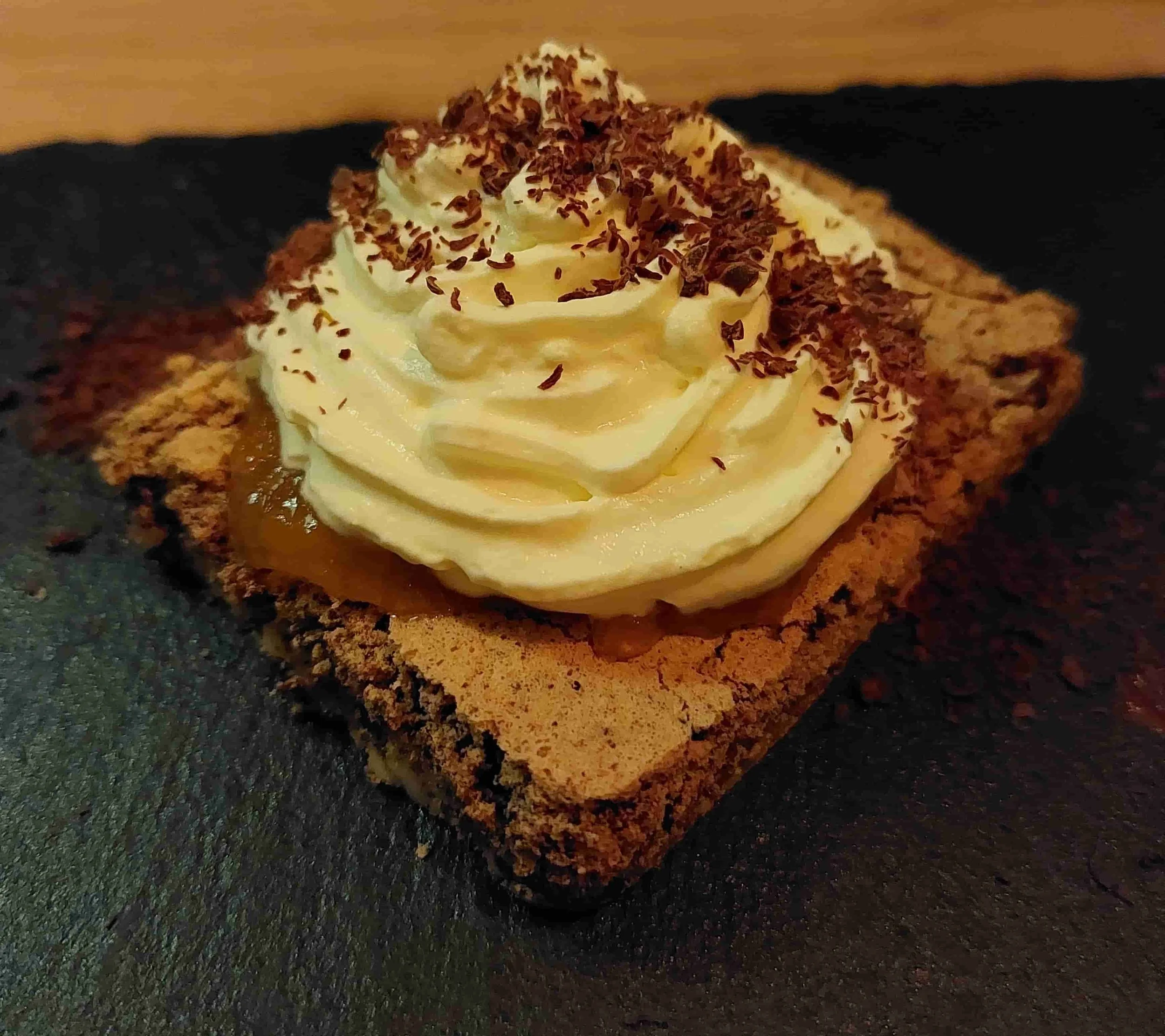 Norwegian Agneskake – traditional sponge cake layered with apricot jam and whipped cream, topped with chocolate flakes