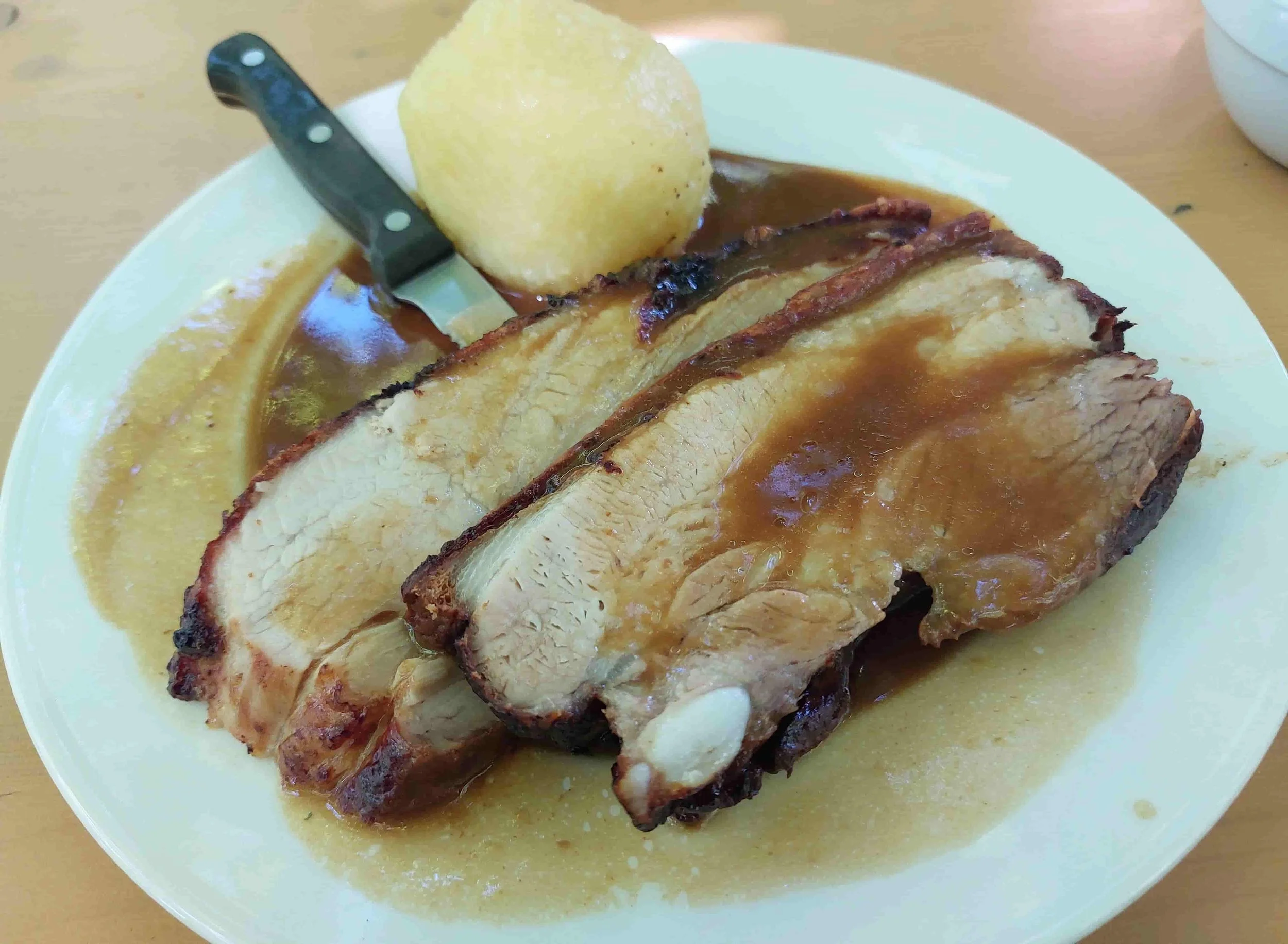 German Krustenbraten roasted pork belly with crispy crackling and gravy
