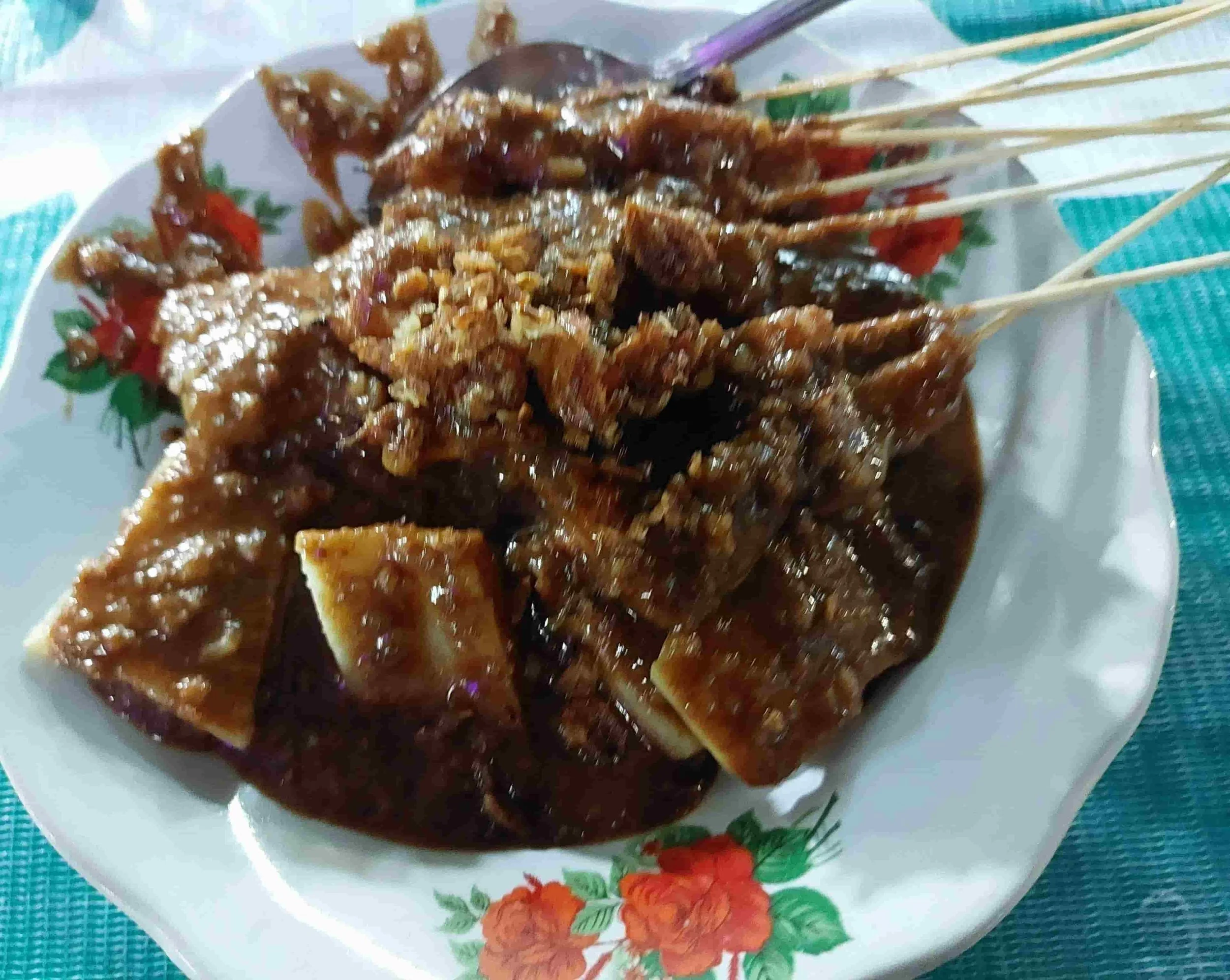 ndonesian sate skewers served with lontong rice cakes and peanut sauce