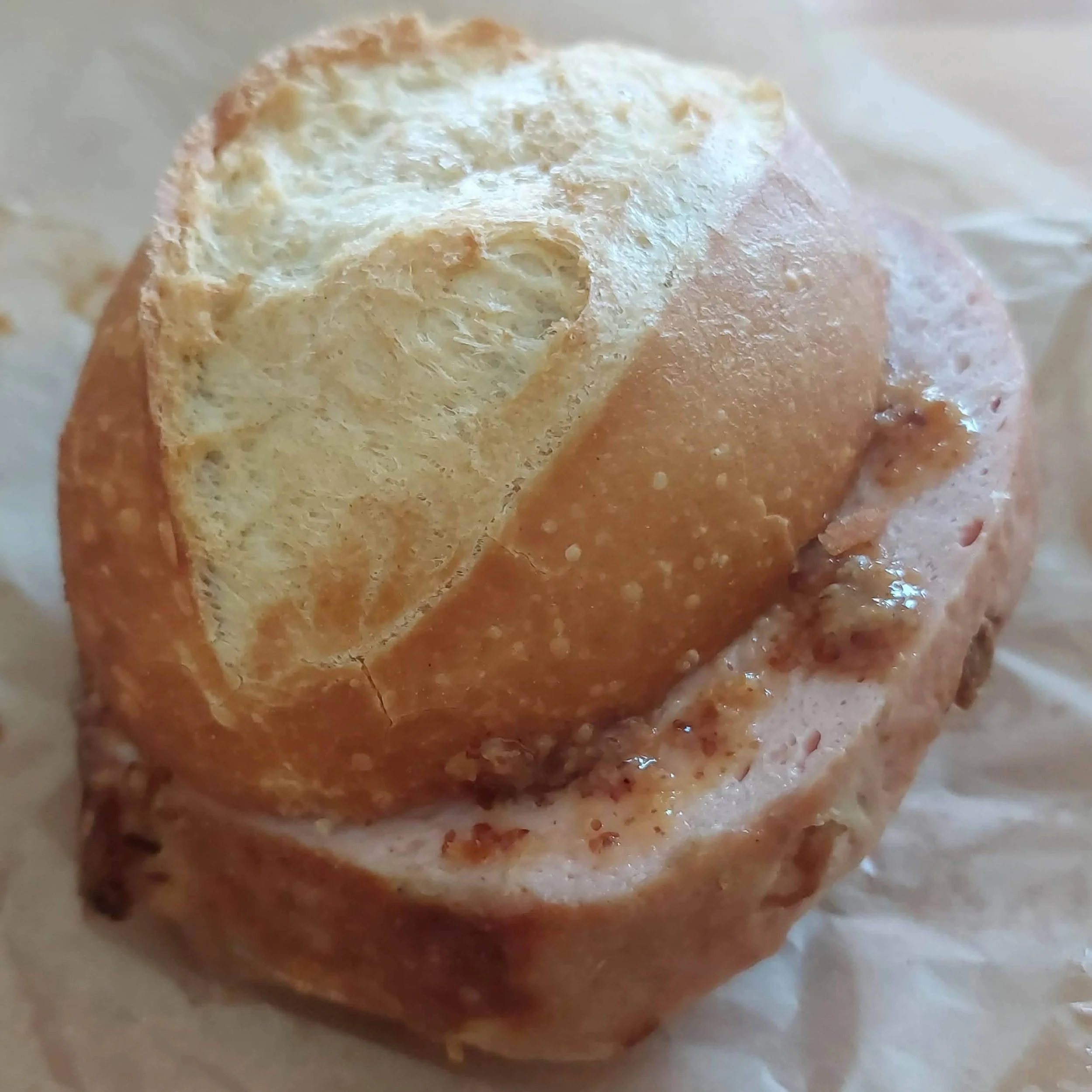 German leberkäse sandwich in a semmel with sweet mustard
