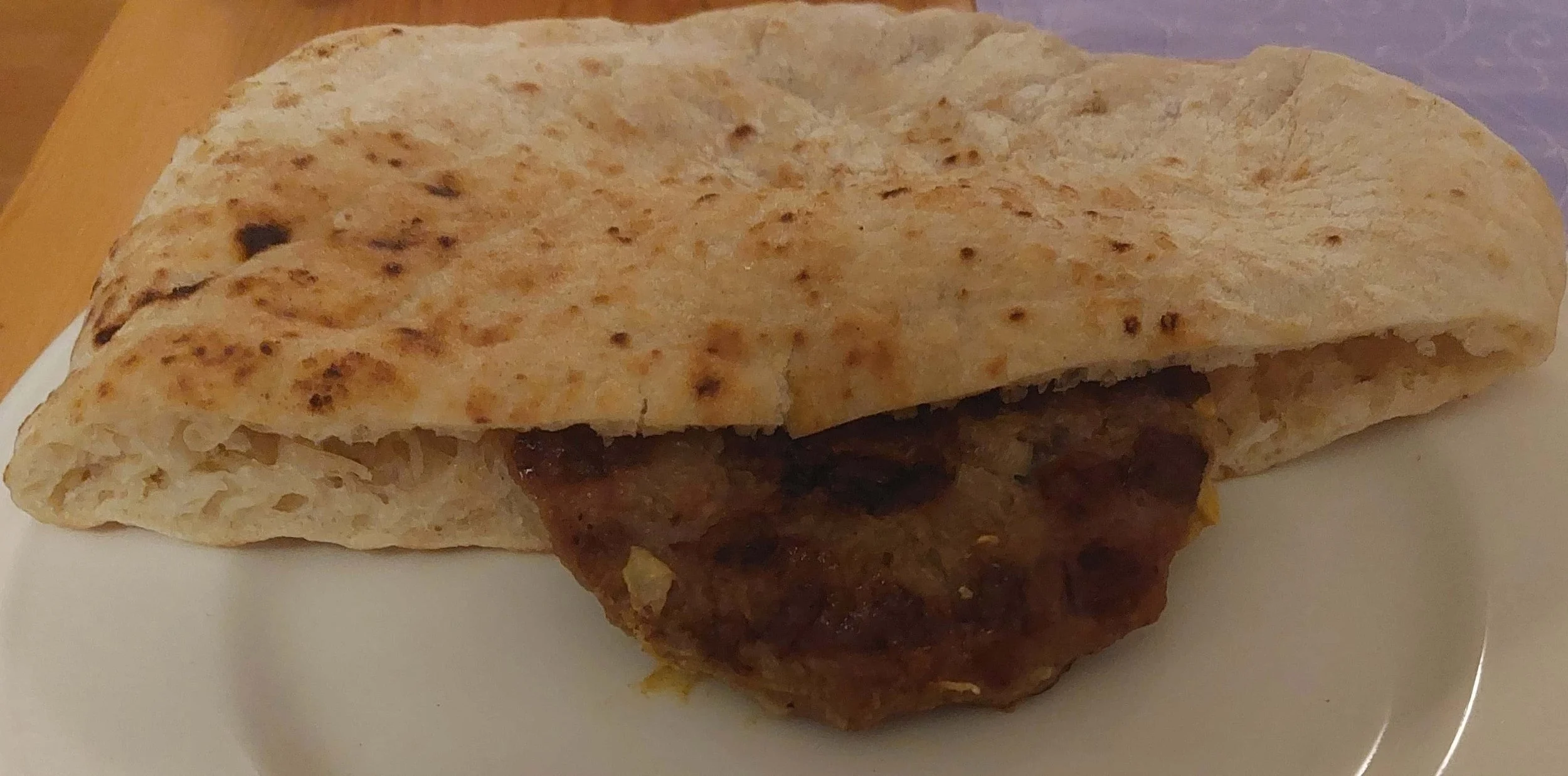Pljeskavica – traditional Serbian grilled minced meat patty served with bread
