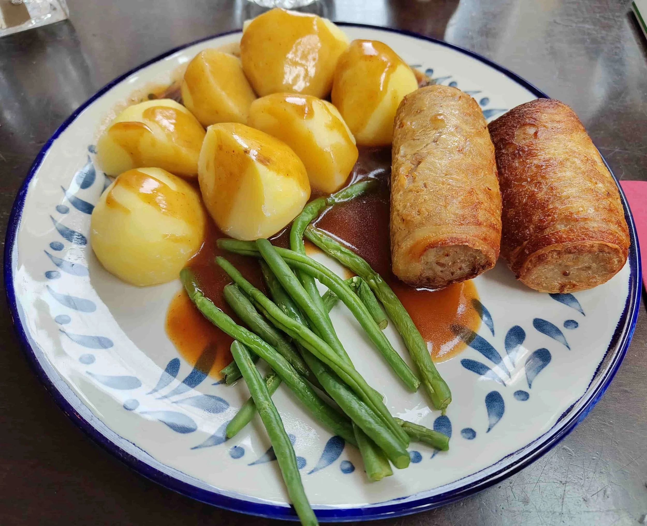 Slavink – Dutch bacon-wrapped minced meat roll served with boiled potatoes and green beans