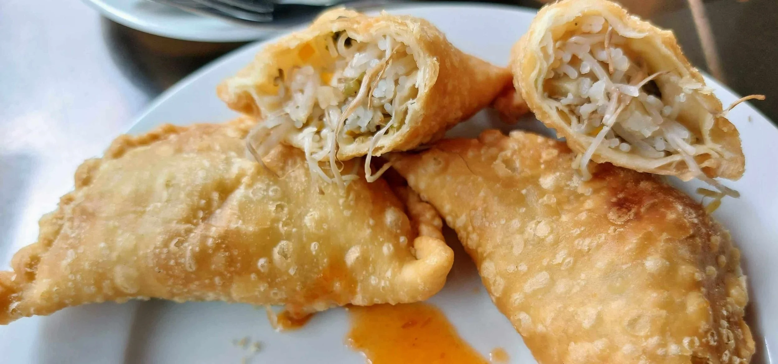 Crispy Indonesian jalangkote stuffed with noodles and vegetables, served with chili sauce