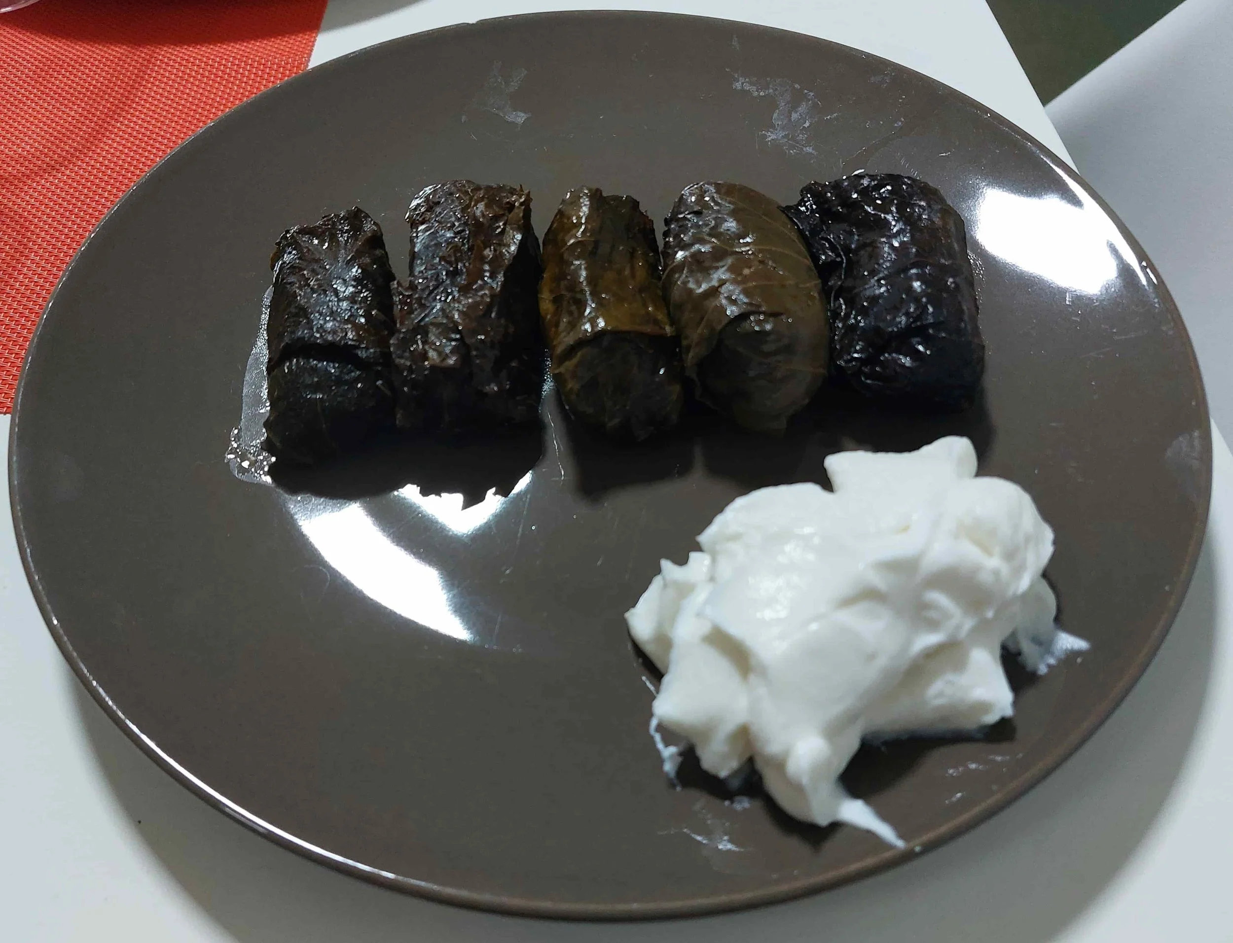North Macedonian japrak grape leaves stuffed with rice and meat served with yoghurt