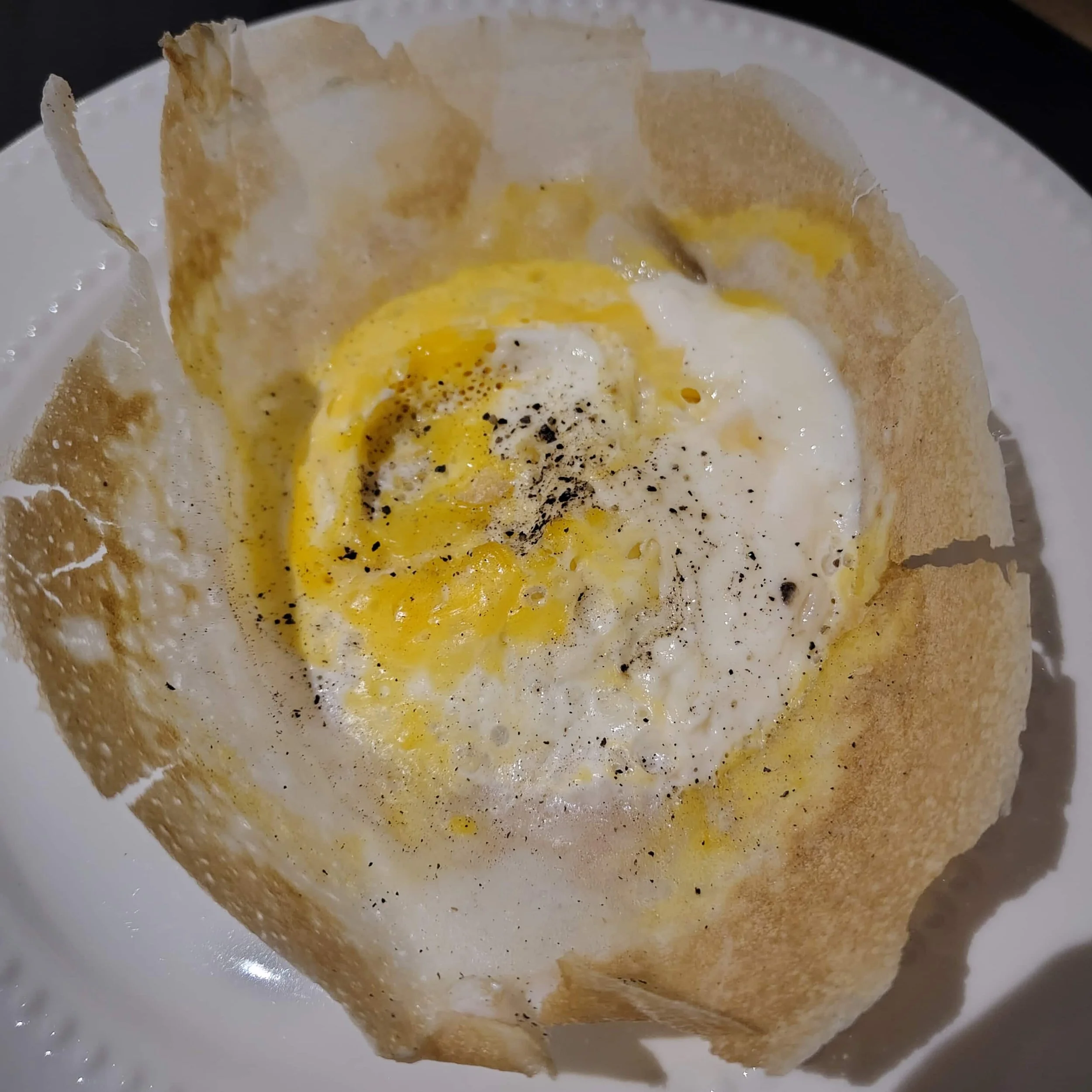 Egg hopper – Sri Lankan bowl-shaped rice flour pancake with a fried egg in the centre